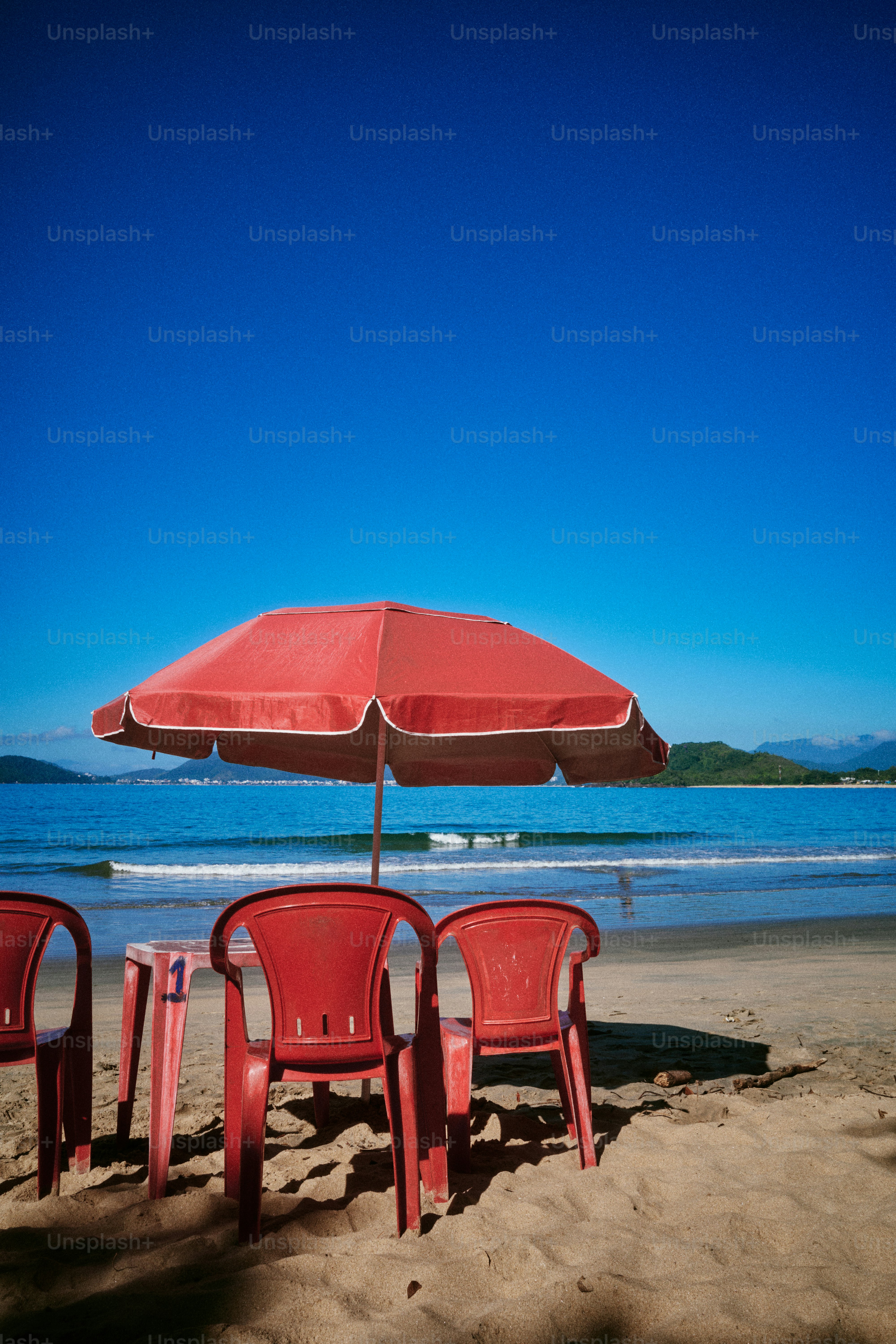 Red chairs and umbrella on a sunny beach
