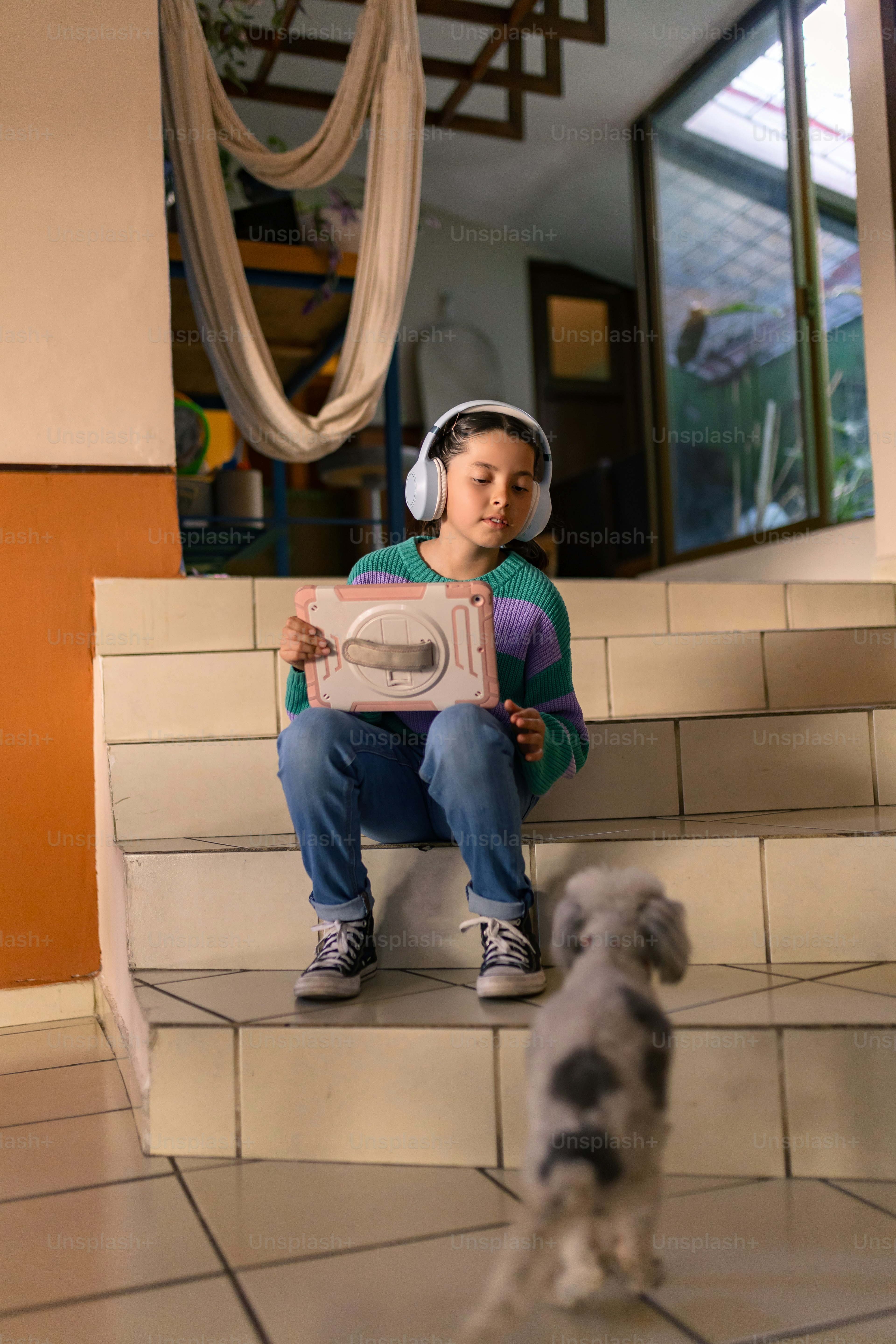 A child listens to music with their dog.
