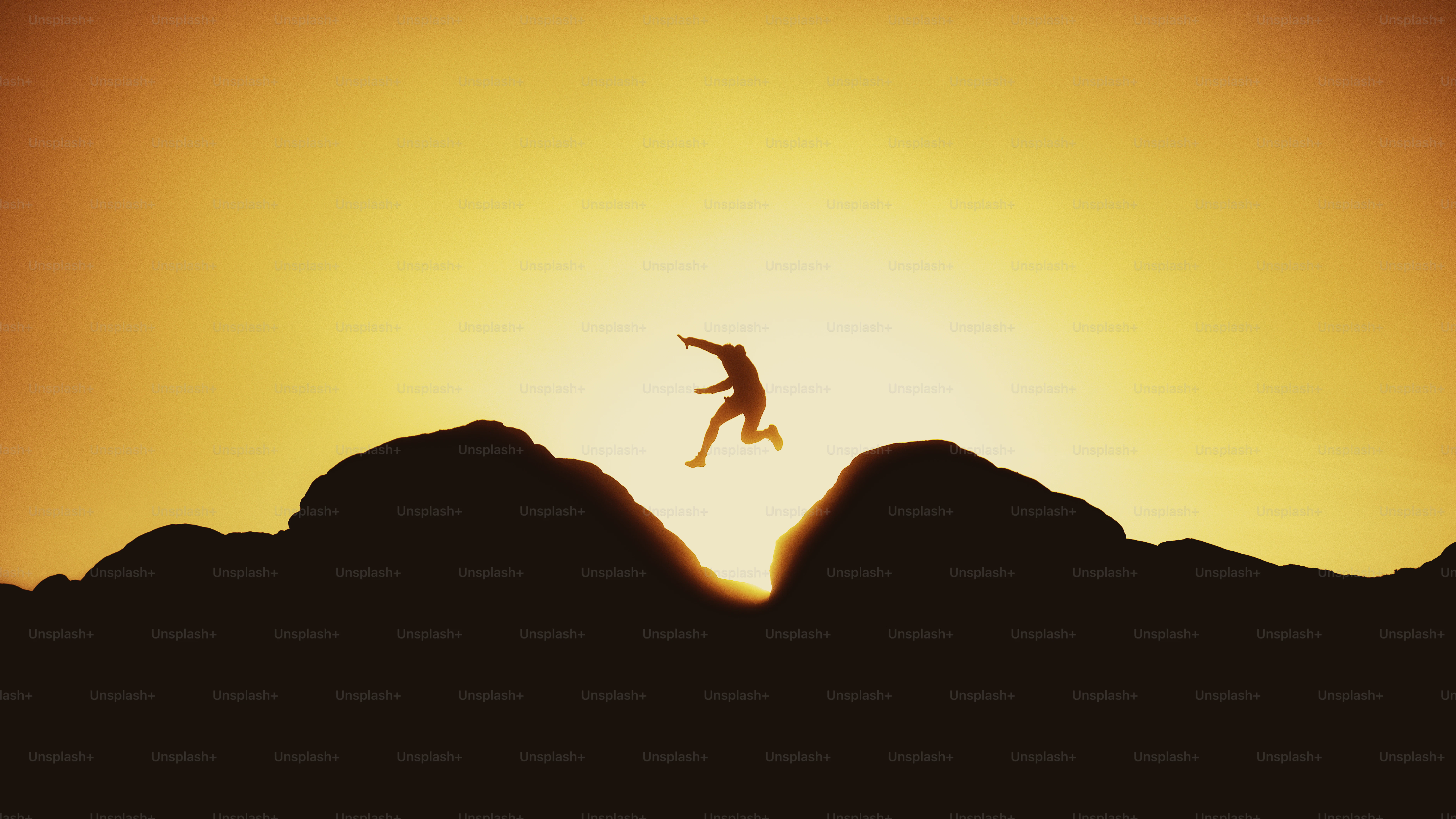 Runner leaping over a mountain gap at sunset. Photo by Joshua Earle on Unsplash.
