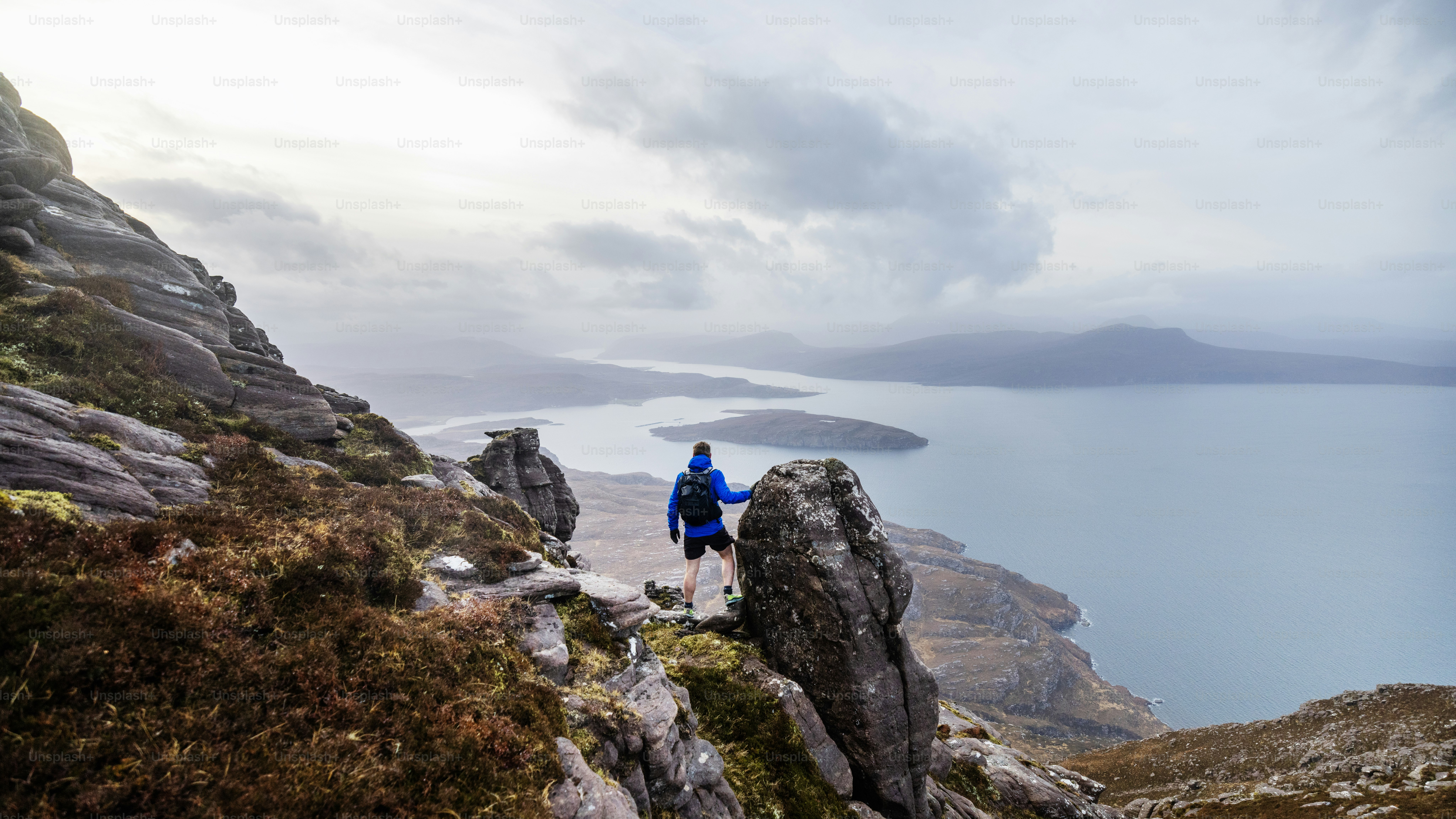 Hiker admires a beautiful coastal landscape view.