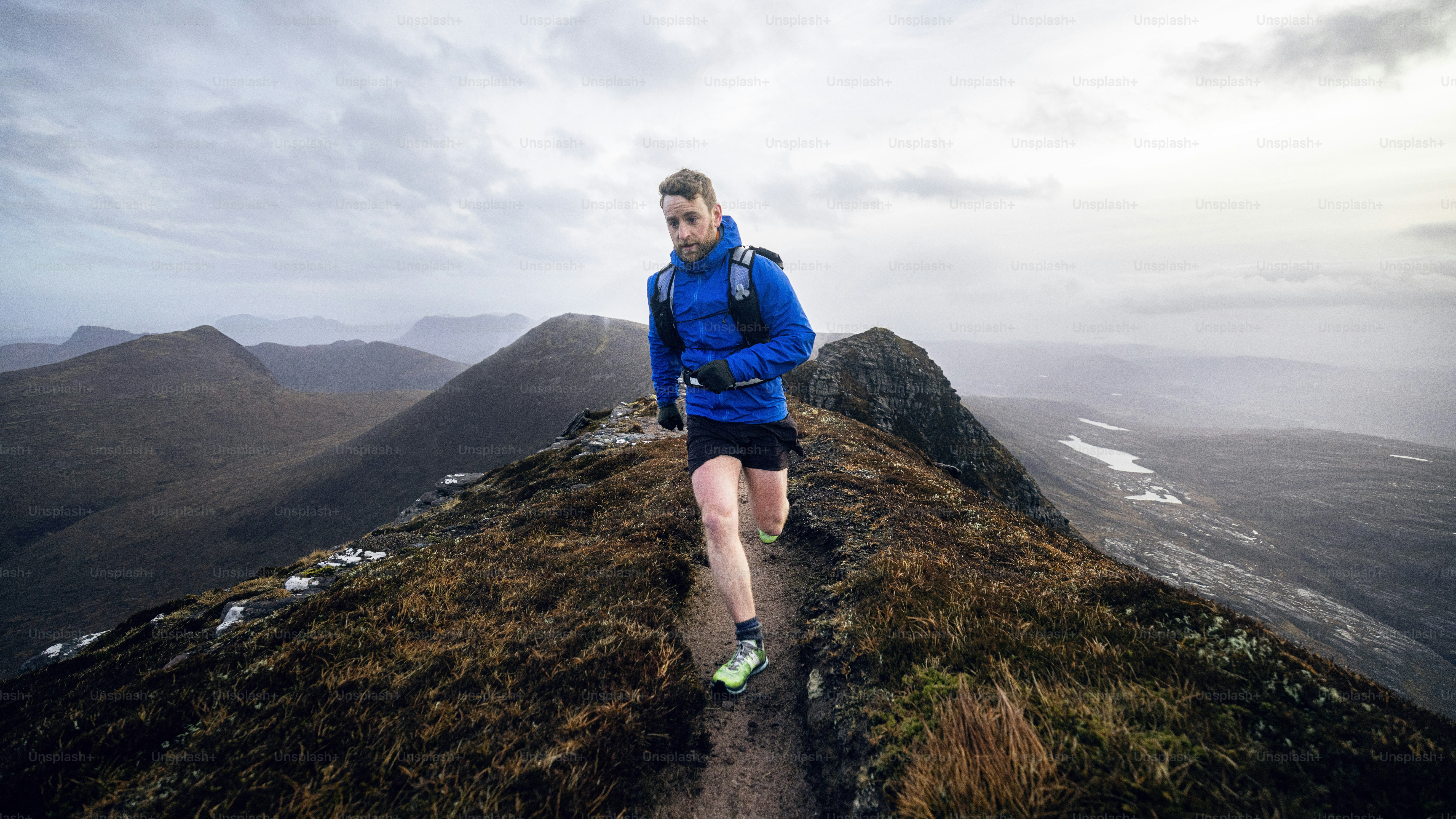 Man runs across a mountain ridge.