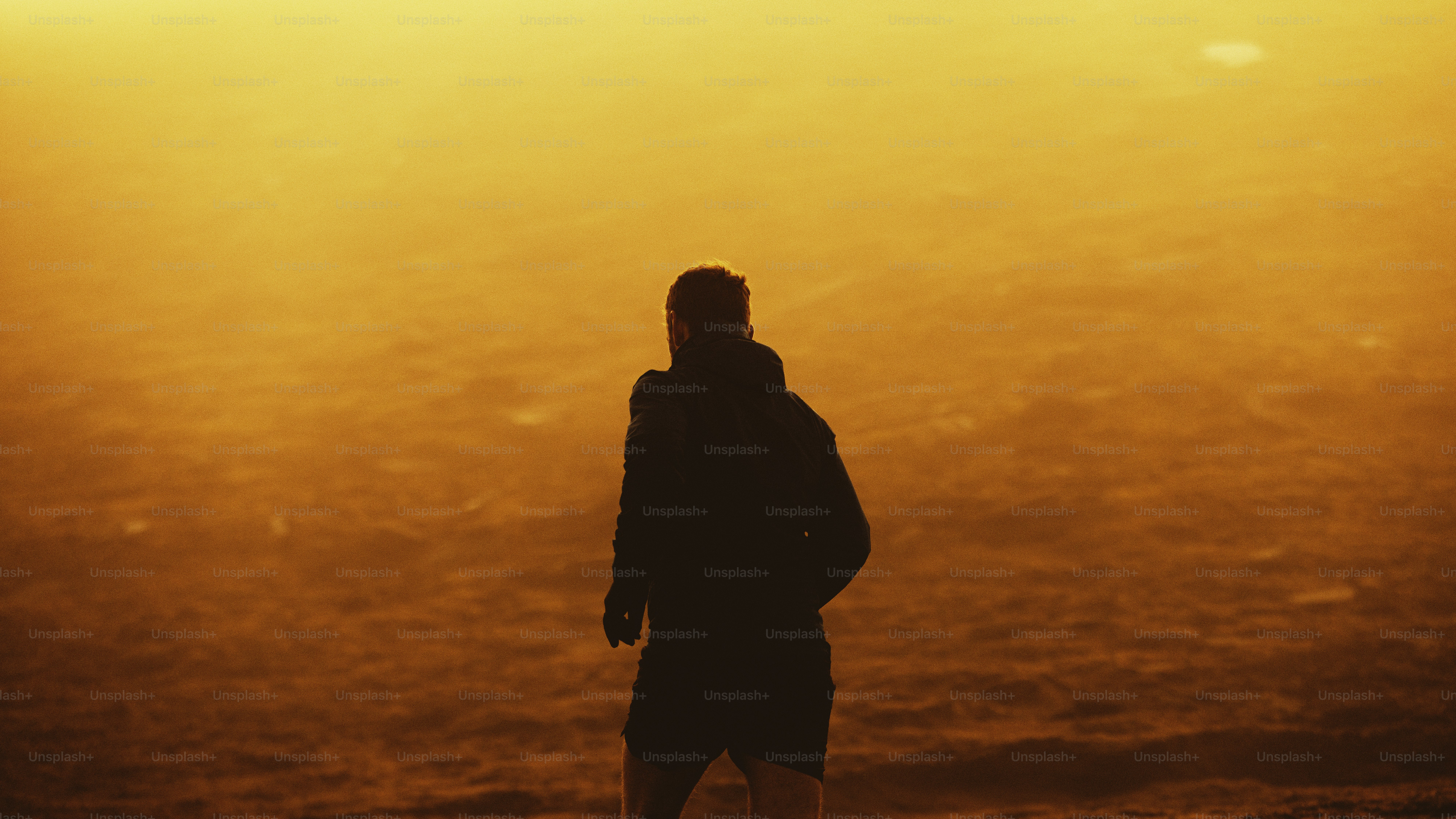 Silhouette of a person against a golden sunset.