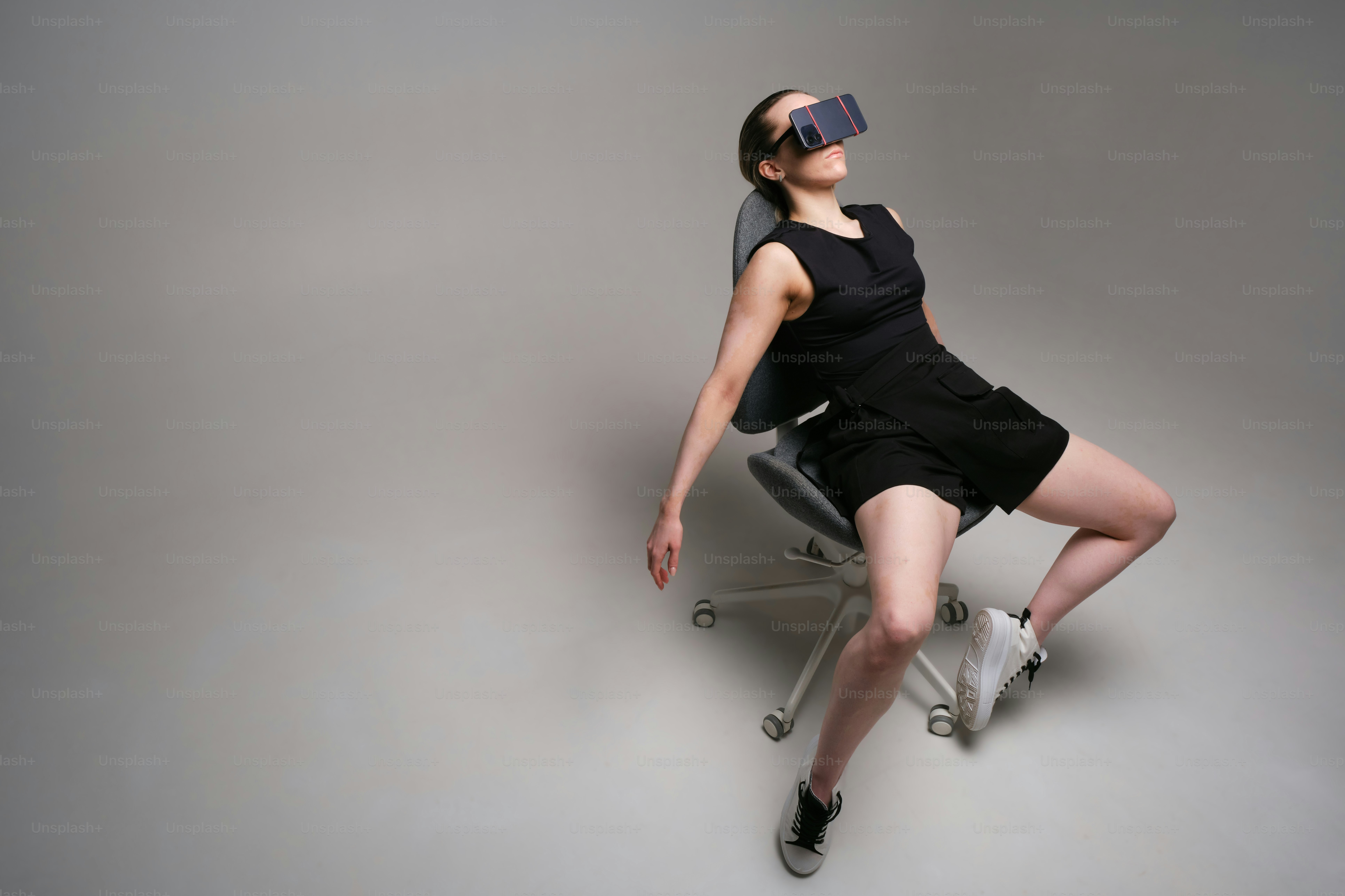 Woman experiences virtual reality while sitting in a chair.