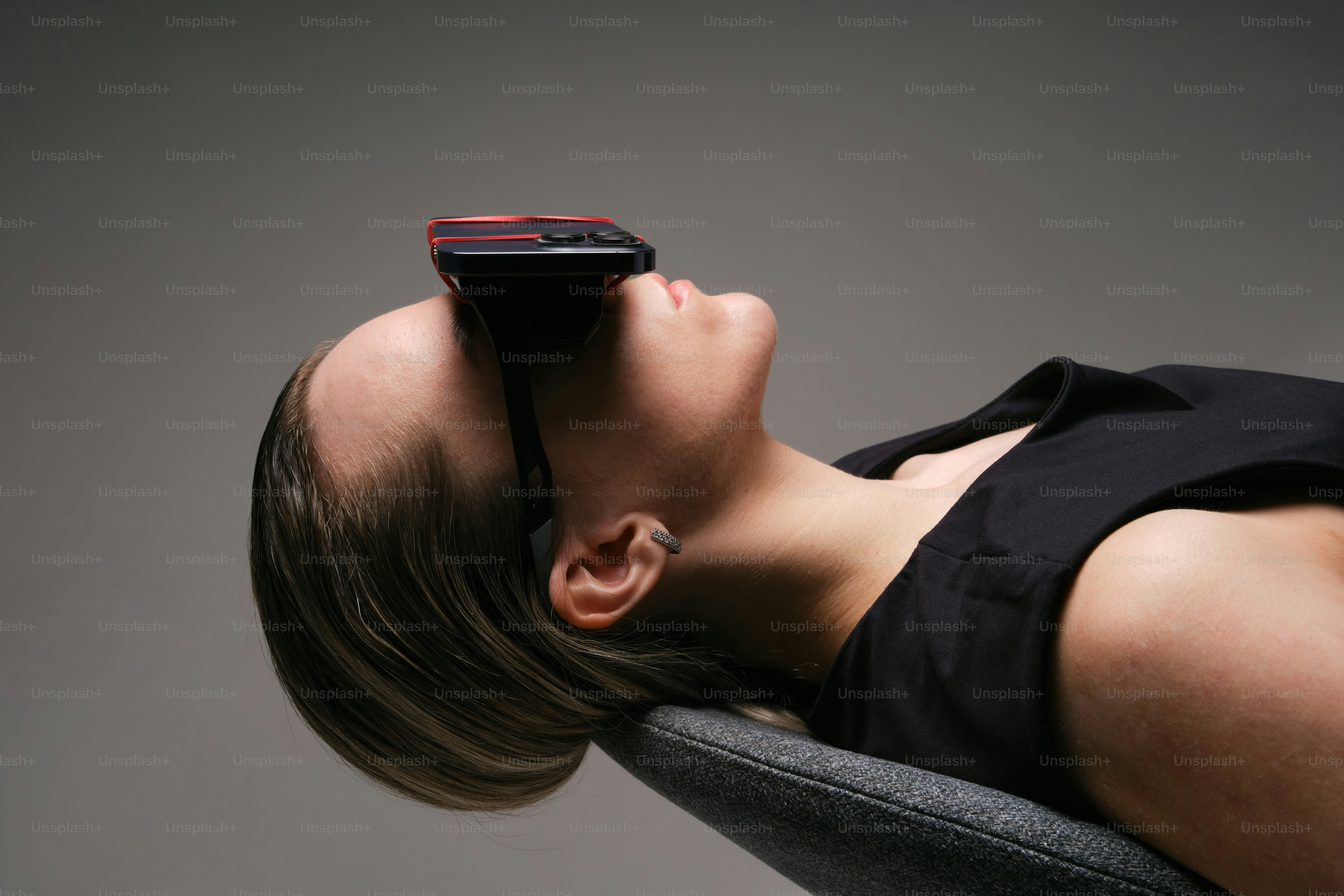 Woman wears vr headset while lying down.