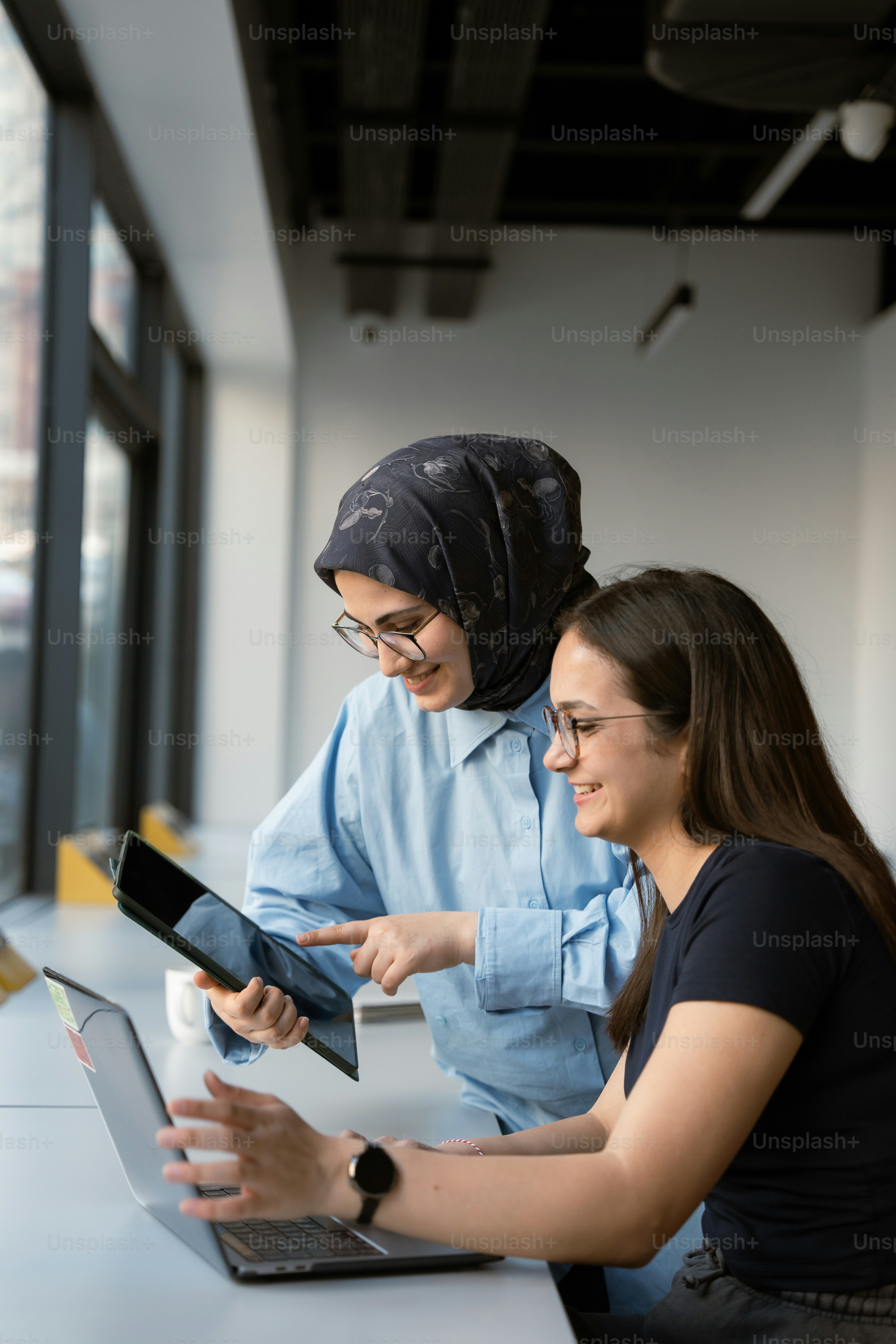 Two women are working together on a project.