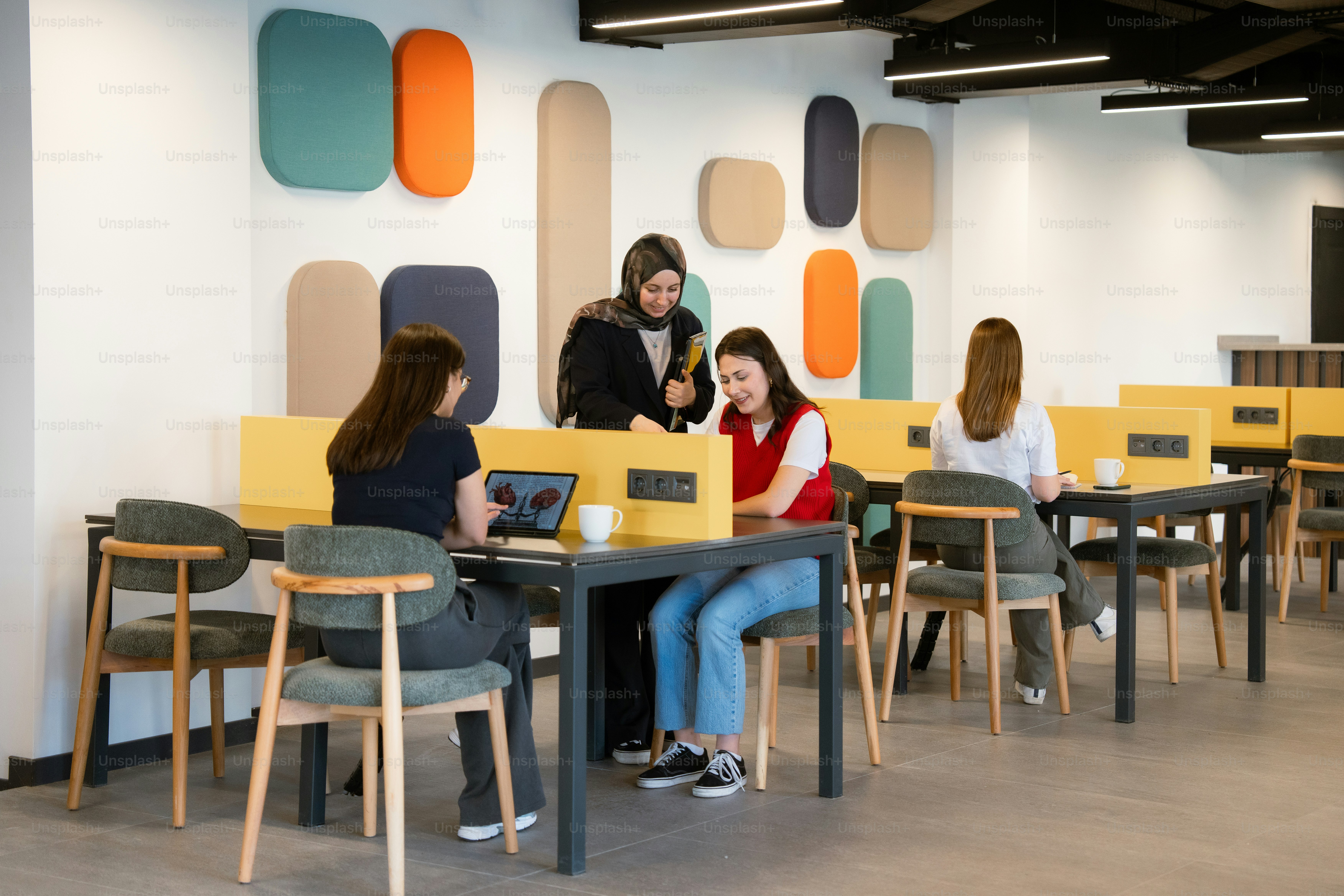 Students collaborate in a modern study space.