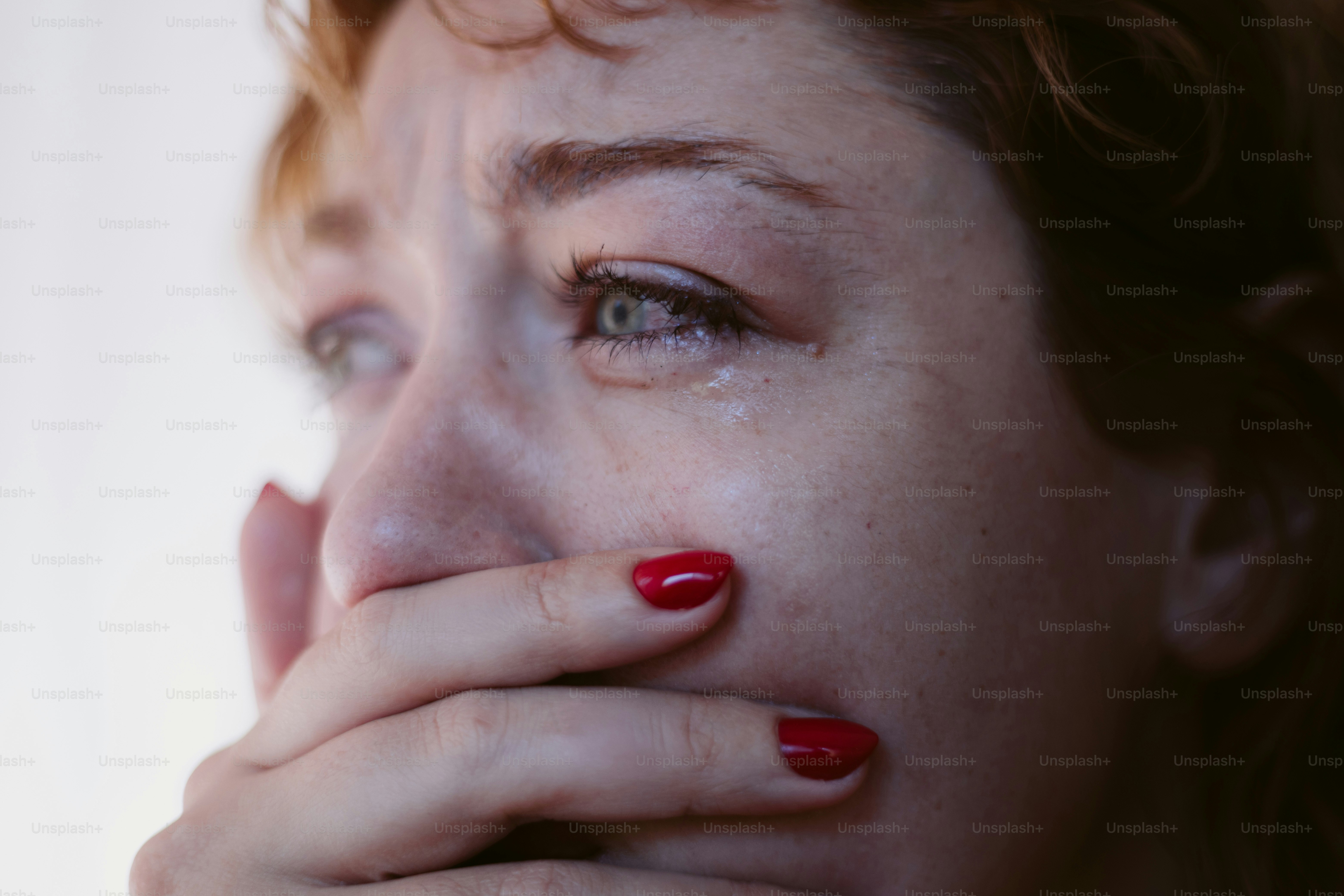 Woman is crying, covering her mouth in distress. photo – Depression ...