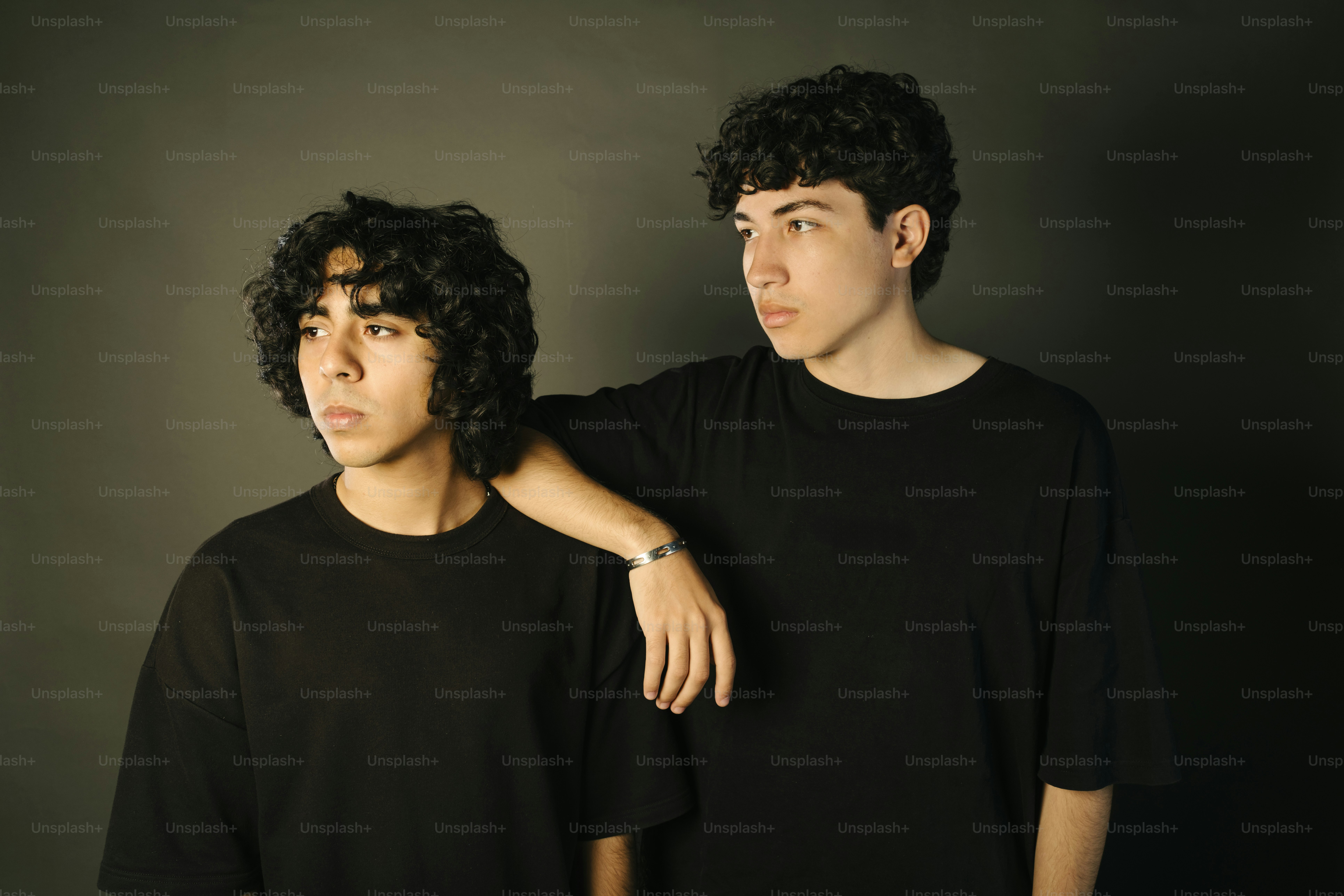 Two young men pose for a photograph.