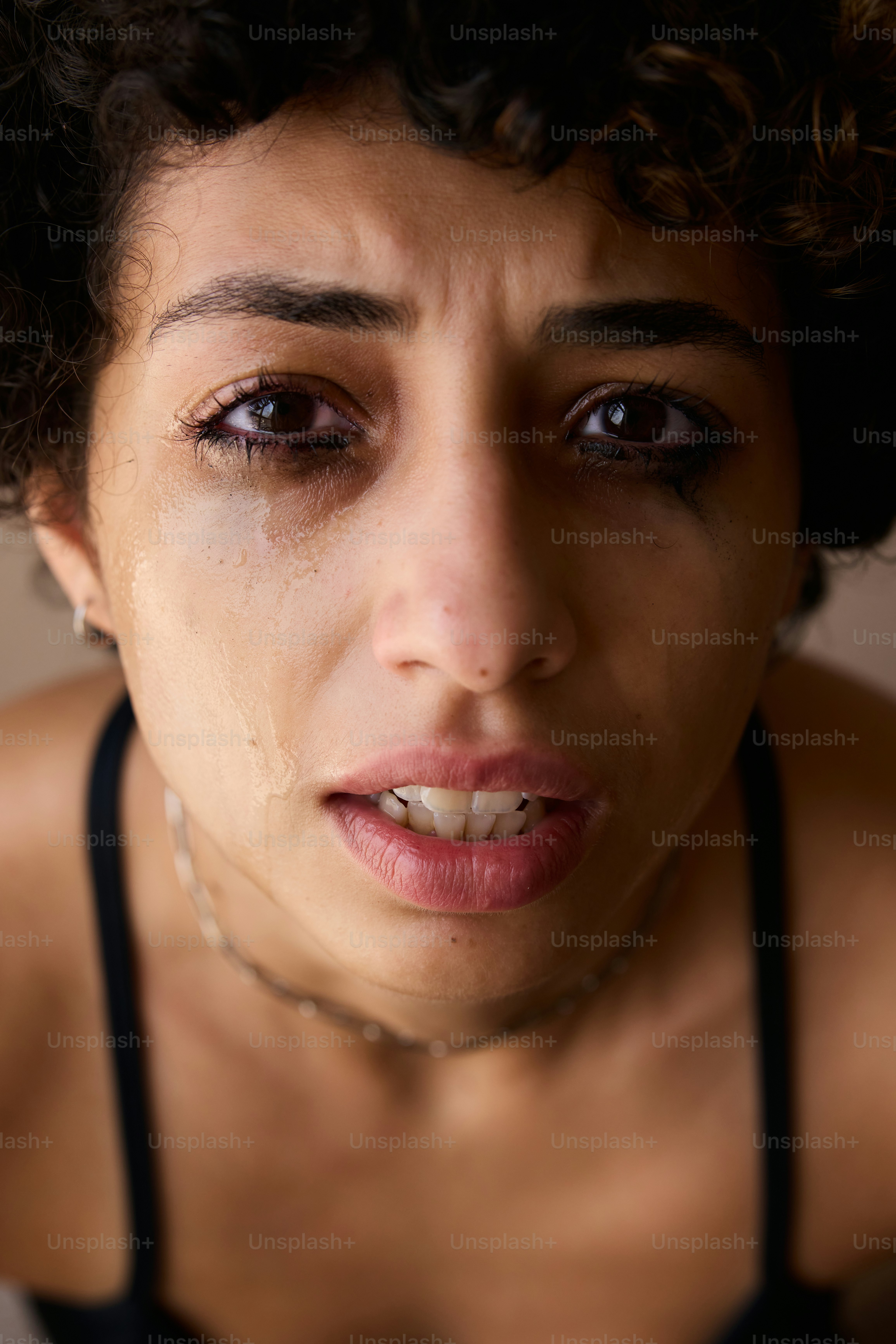 A woman is crying with tears running down.