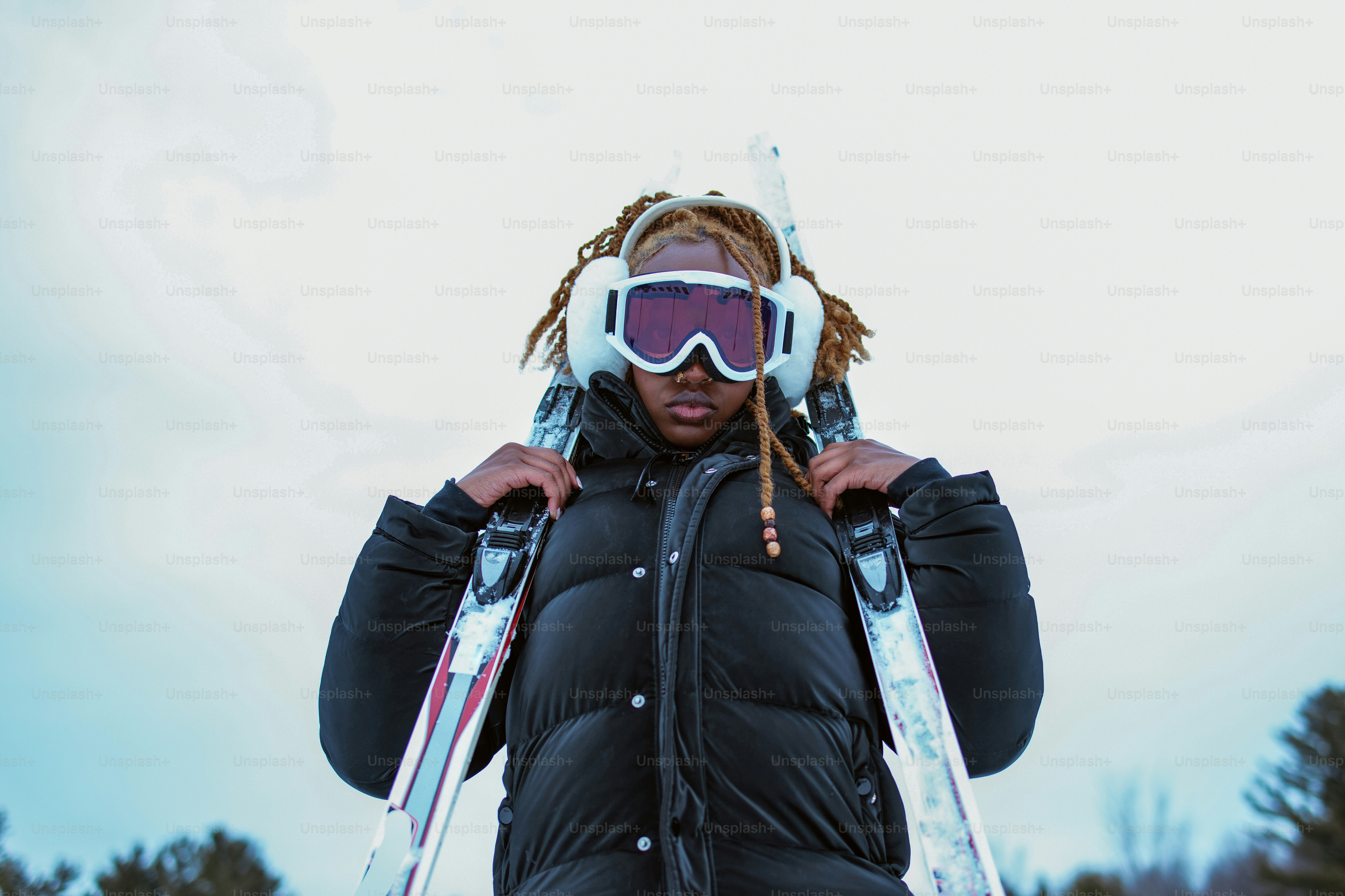 Person with skis, ready for the slopes.