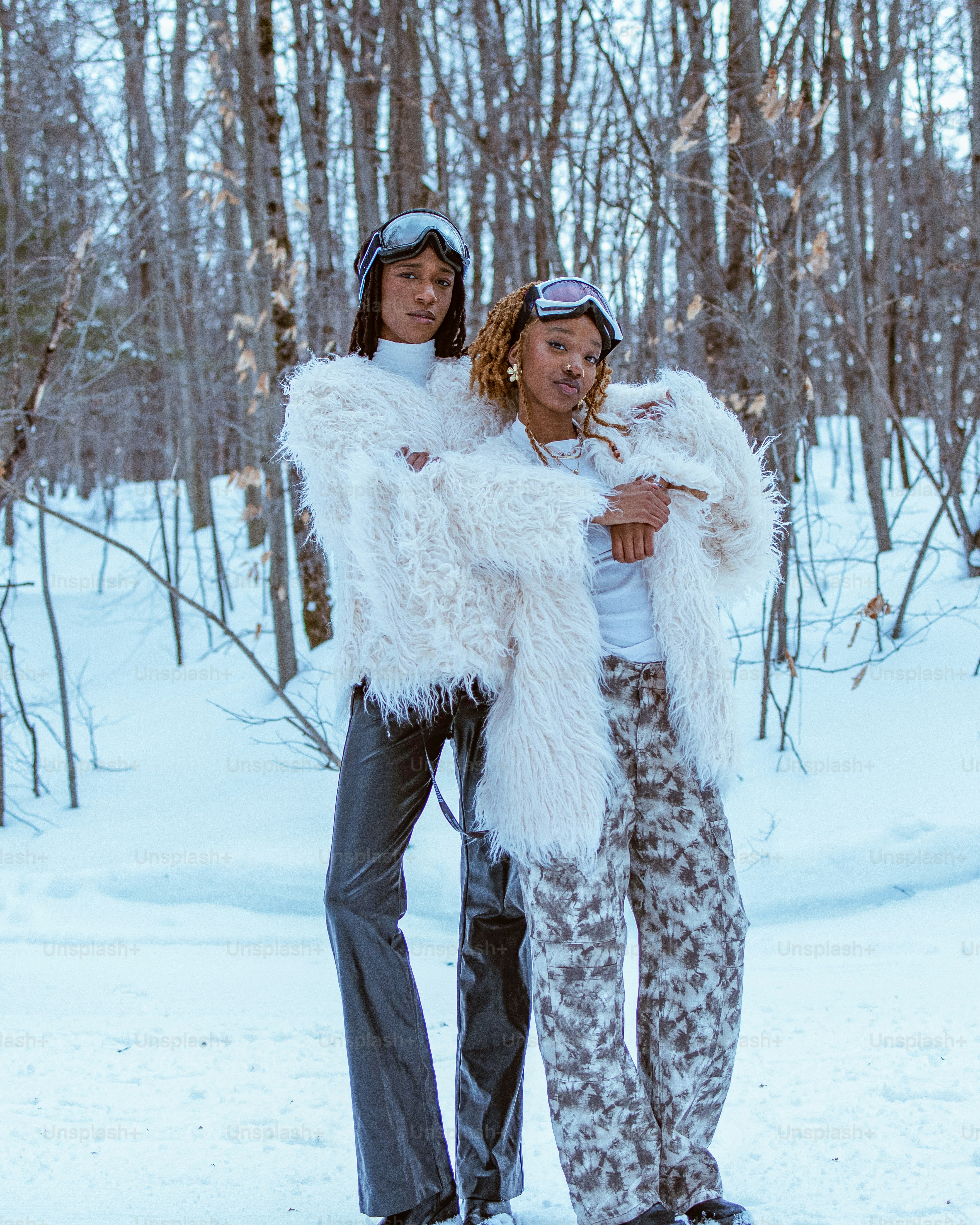 Two people pose in the snow.