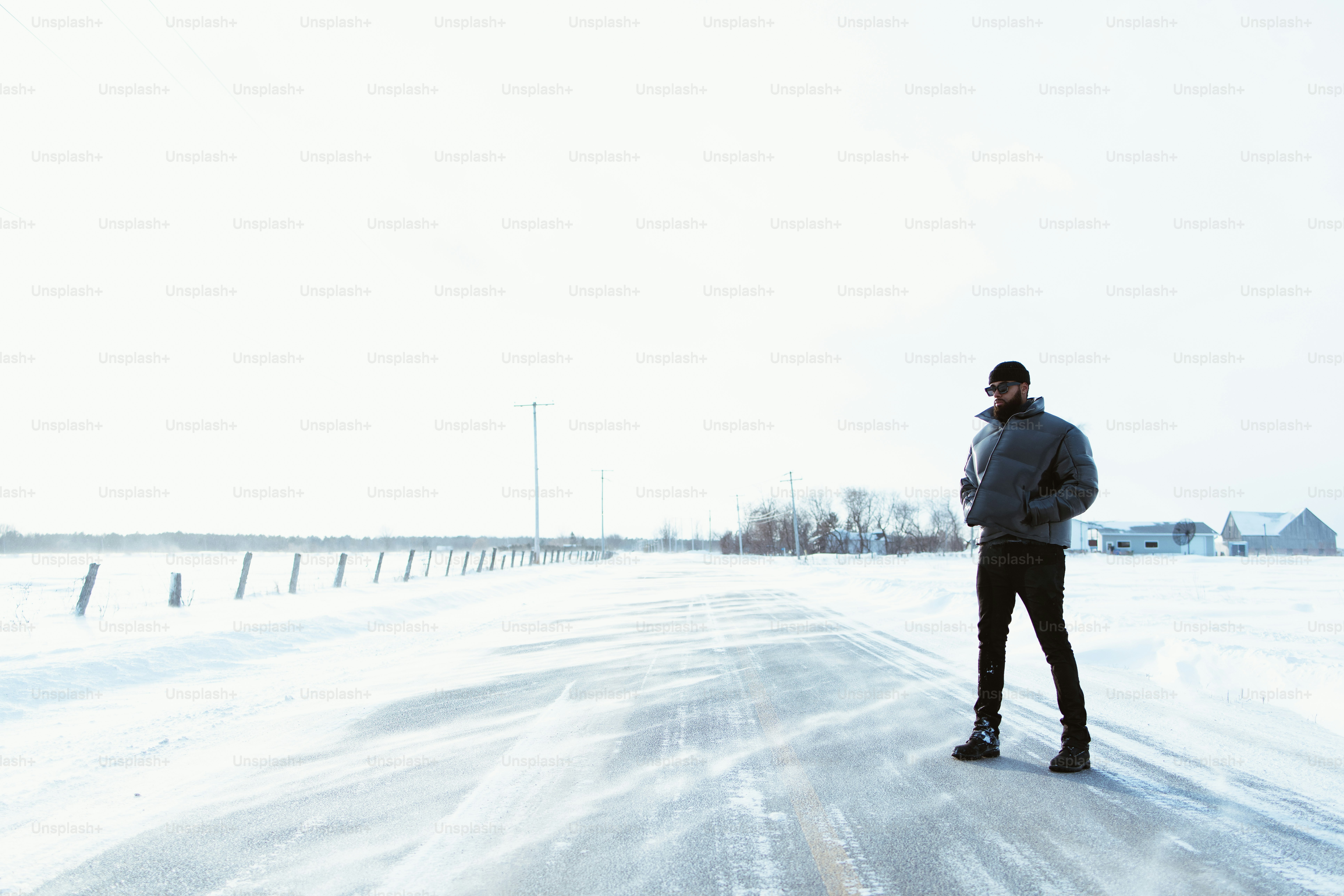 Man stands on snowy road.