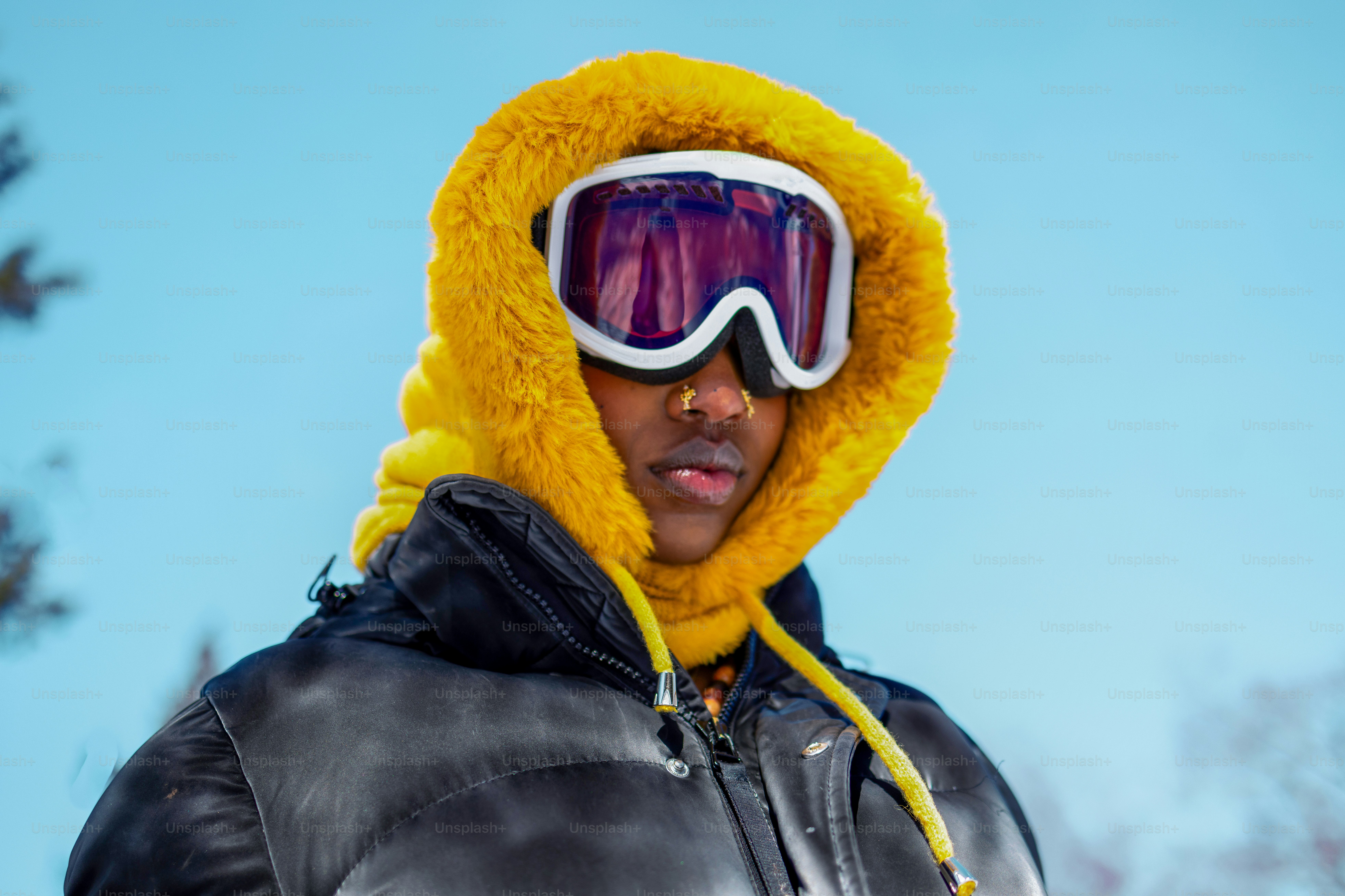 Person in ski gear, hooded jacket, and goggles.