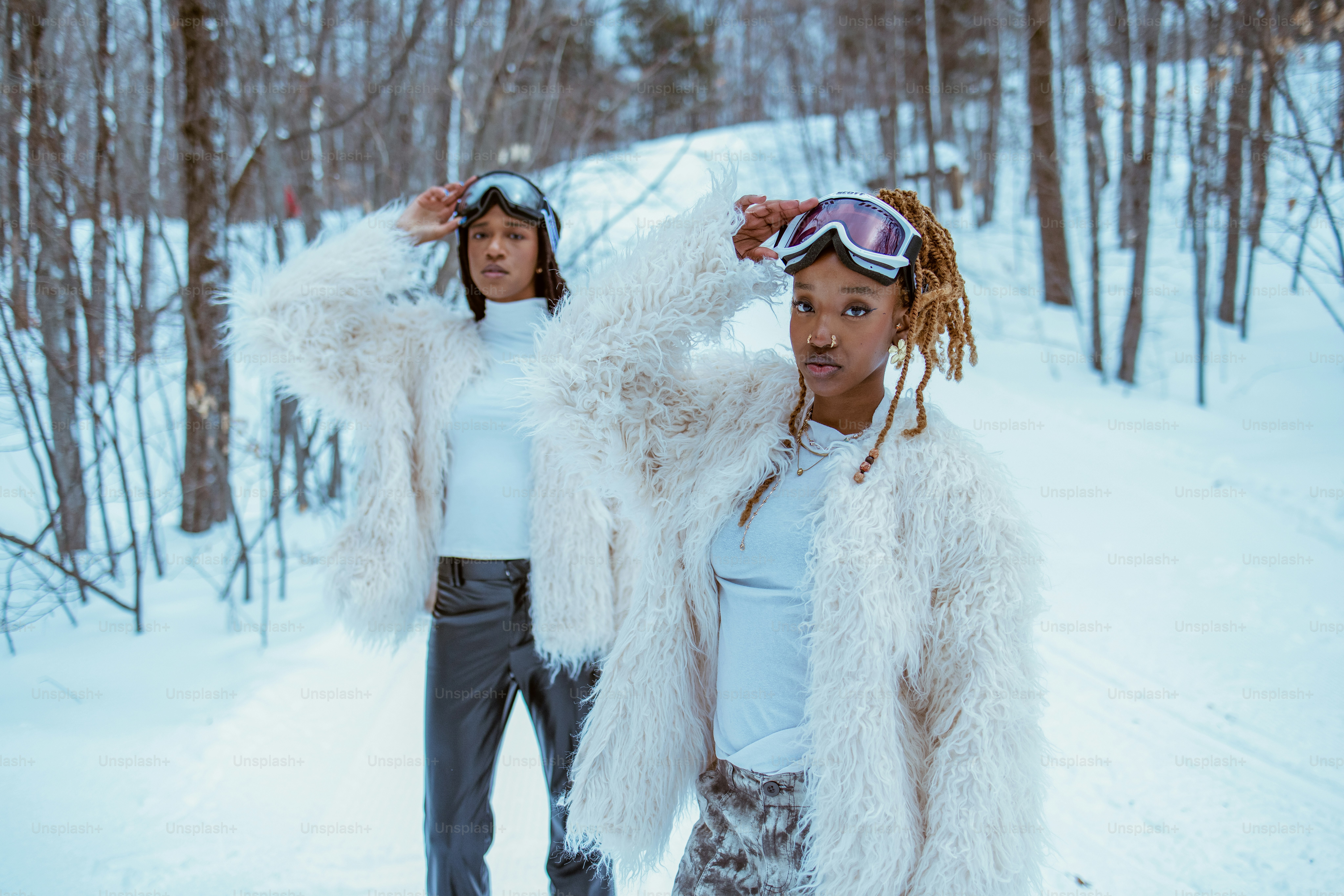 Two women pose in winter attire.