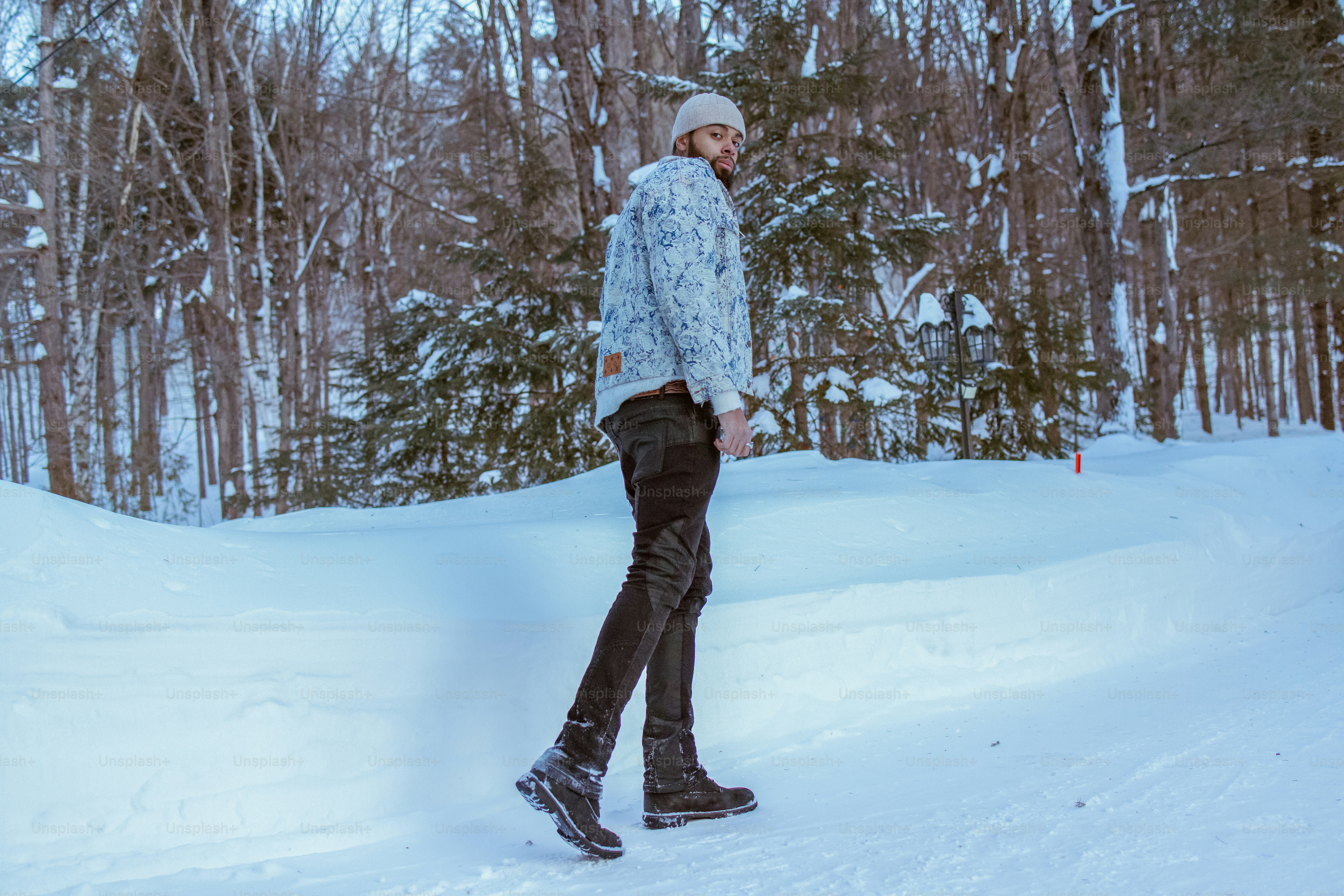 Man walks through the snowy winter forest.