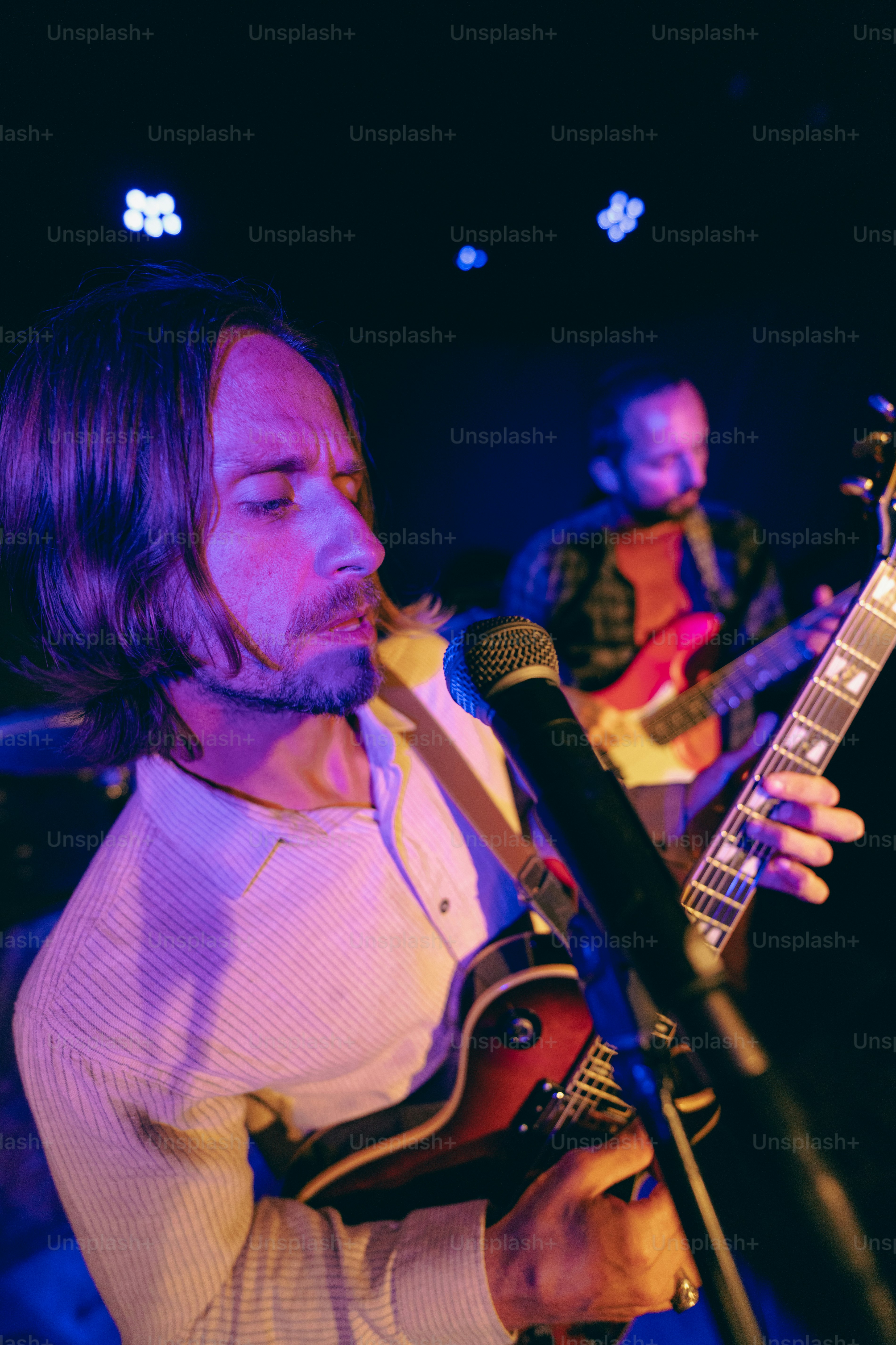 Band members performing live music on stage