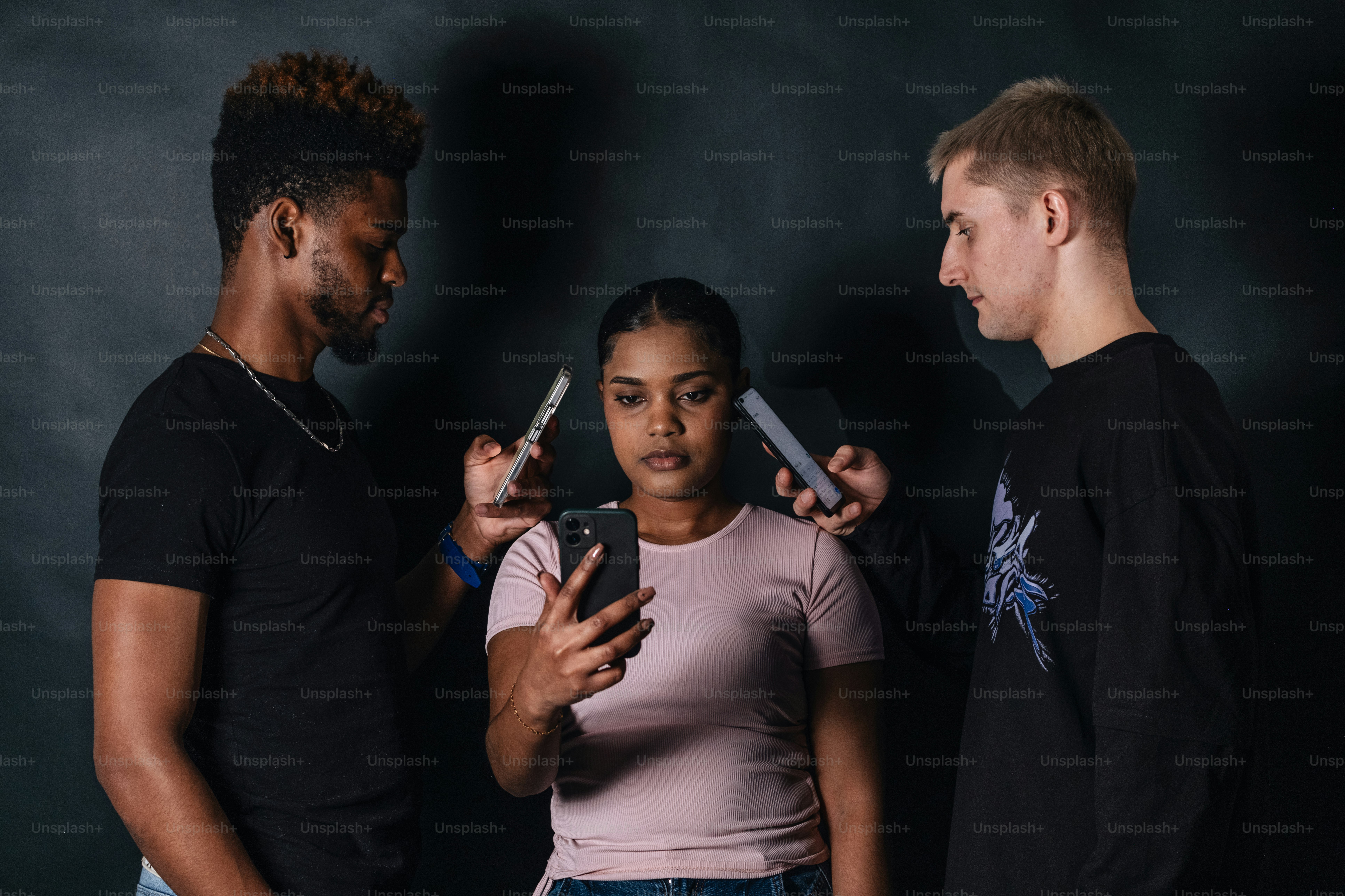 Two men threaten a woman taking a selfie.