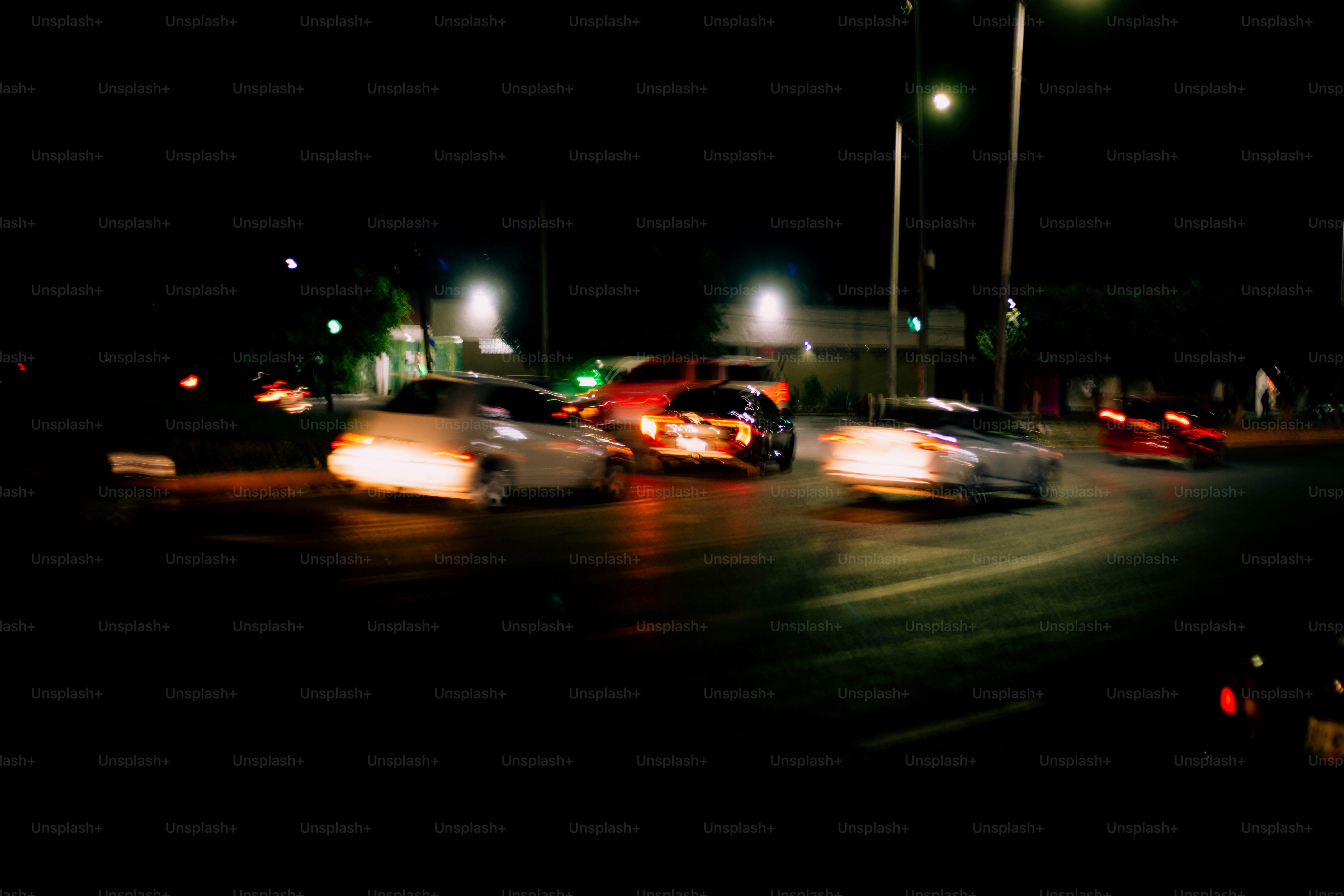 Cars are racing at night with bright headlights.