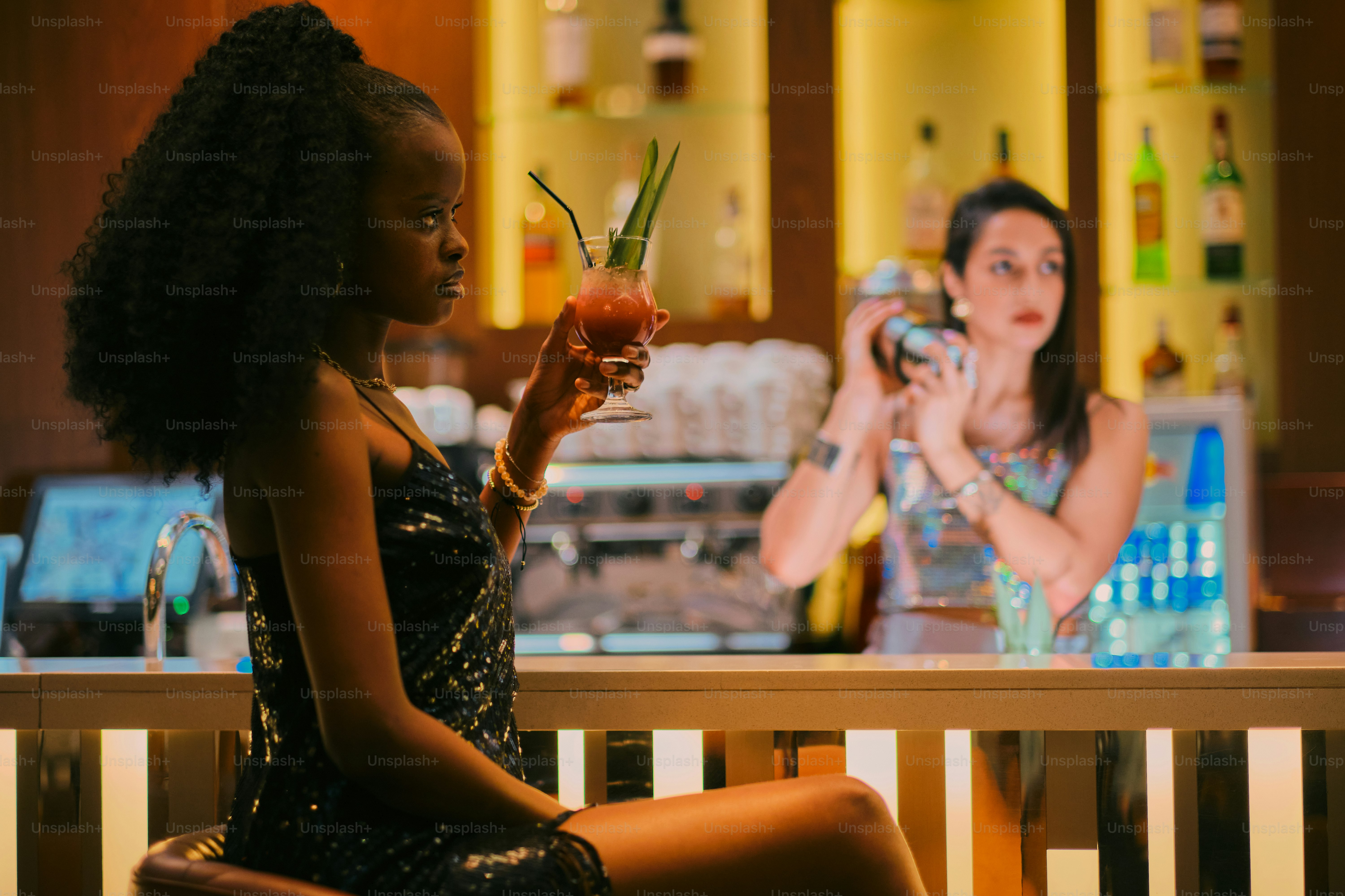 Woman in a bar enjoys a cocktail and a smartphone. photo – People Image ...