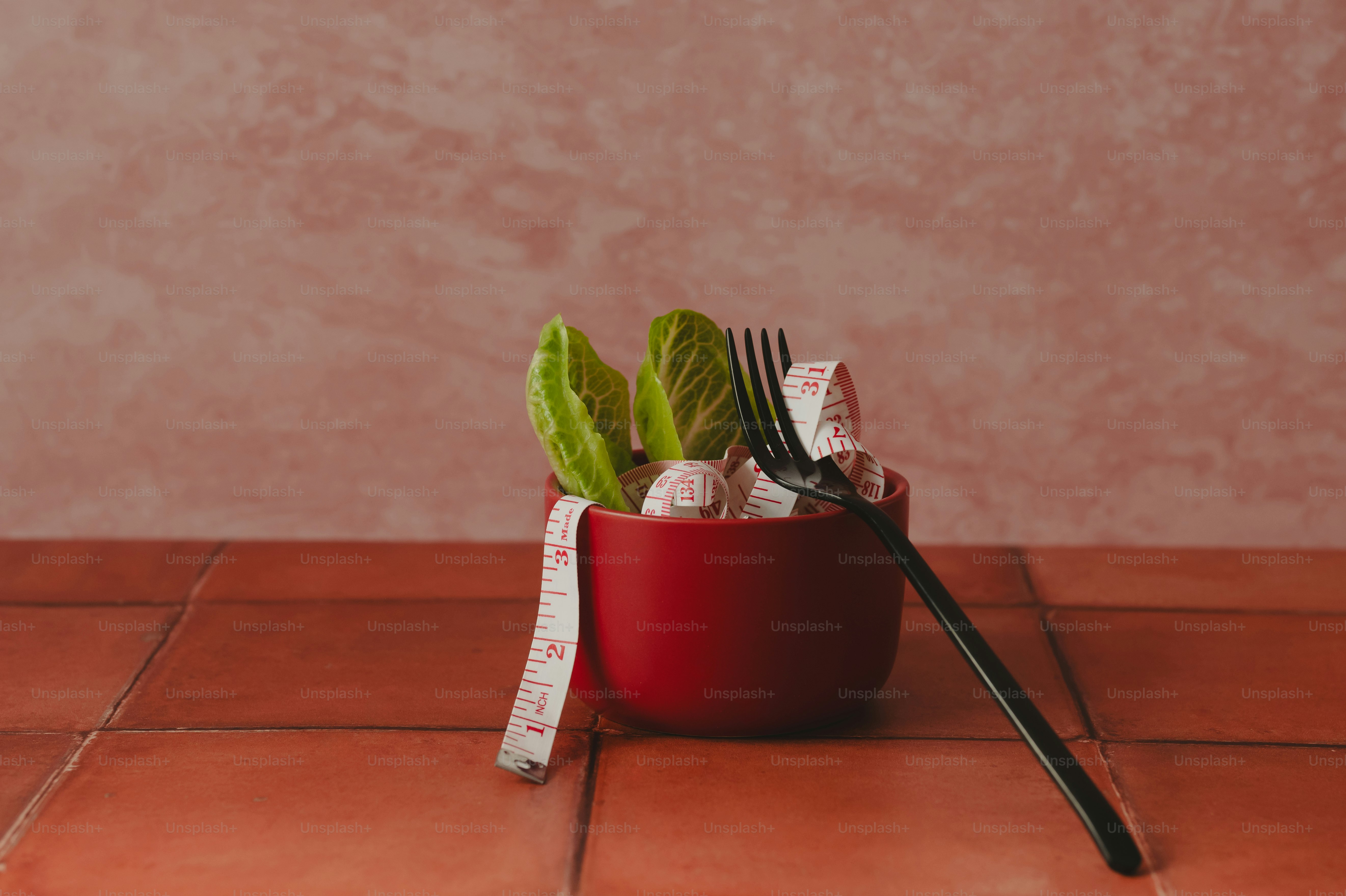 Healthy food in a bowl with a measuring tape.