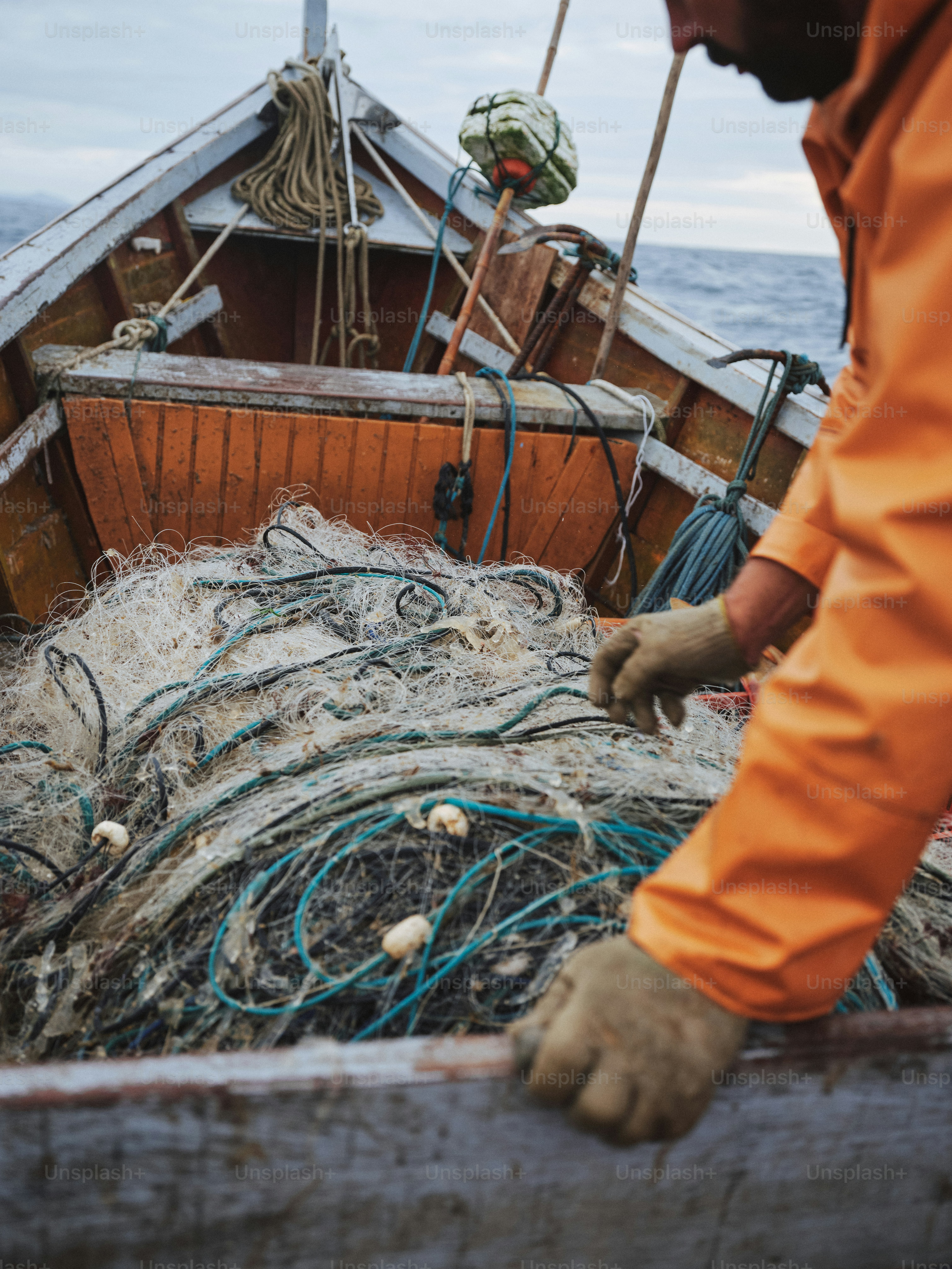 Ein Fischer arbeitet an seinem Fischernetz.