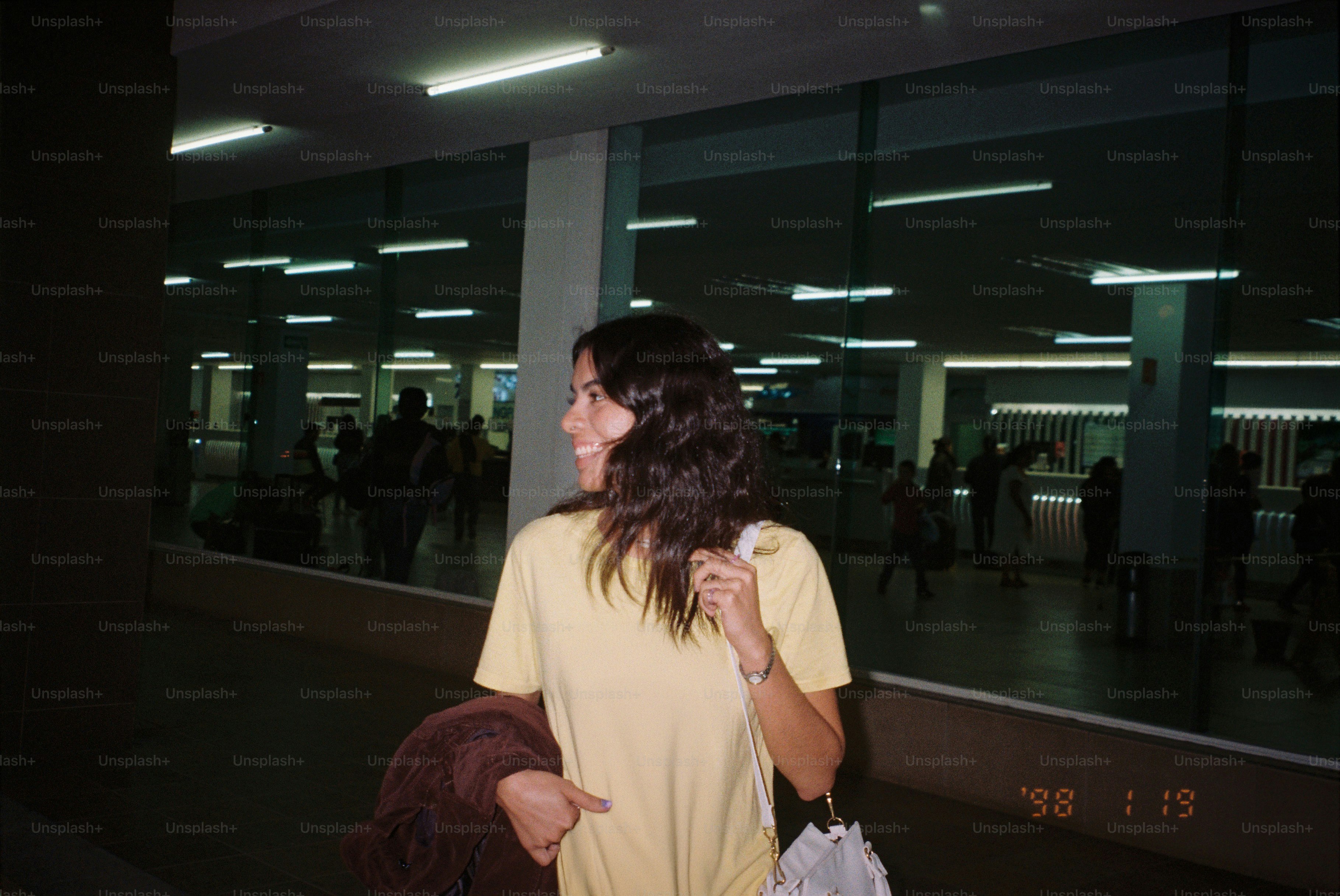 Woman smiles while walking through a terminal.