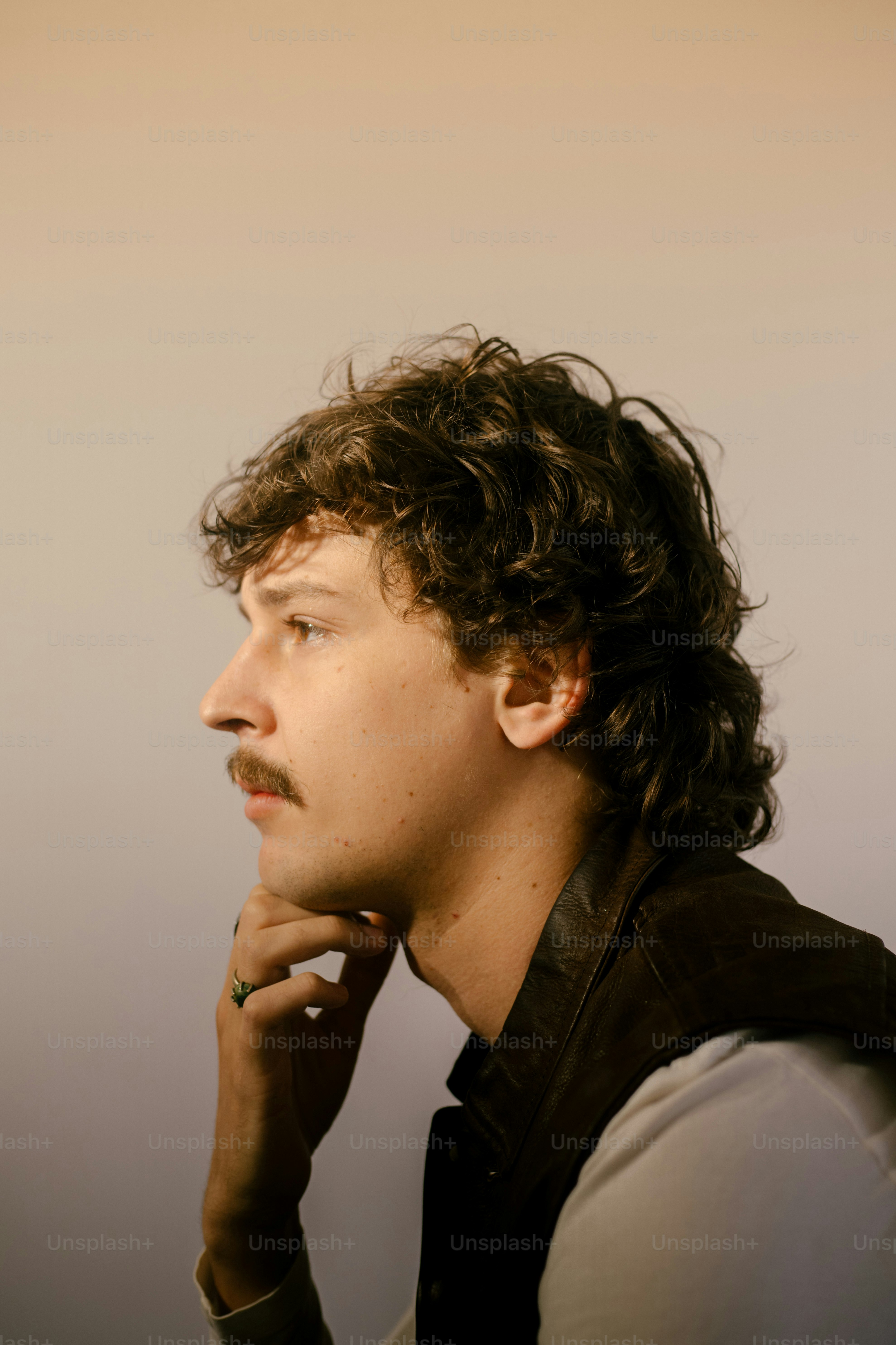 A man poses with a thoughtful expression.