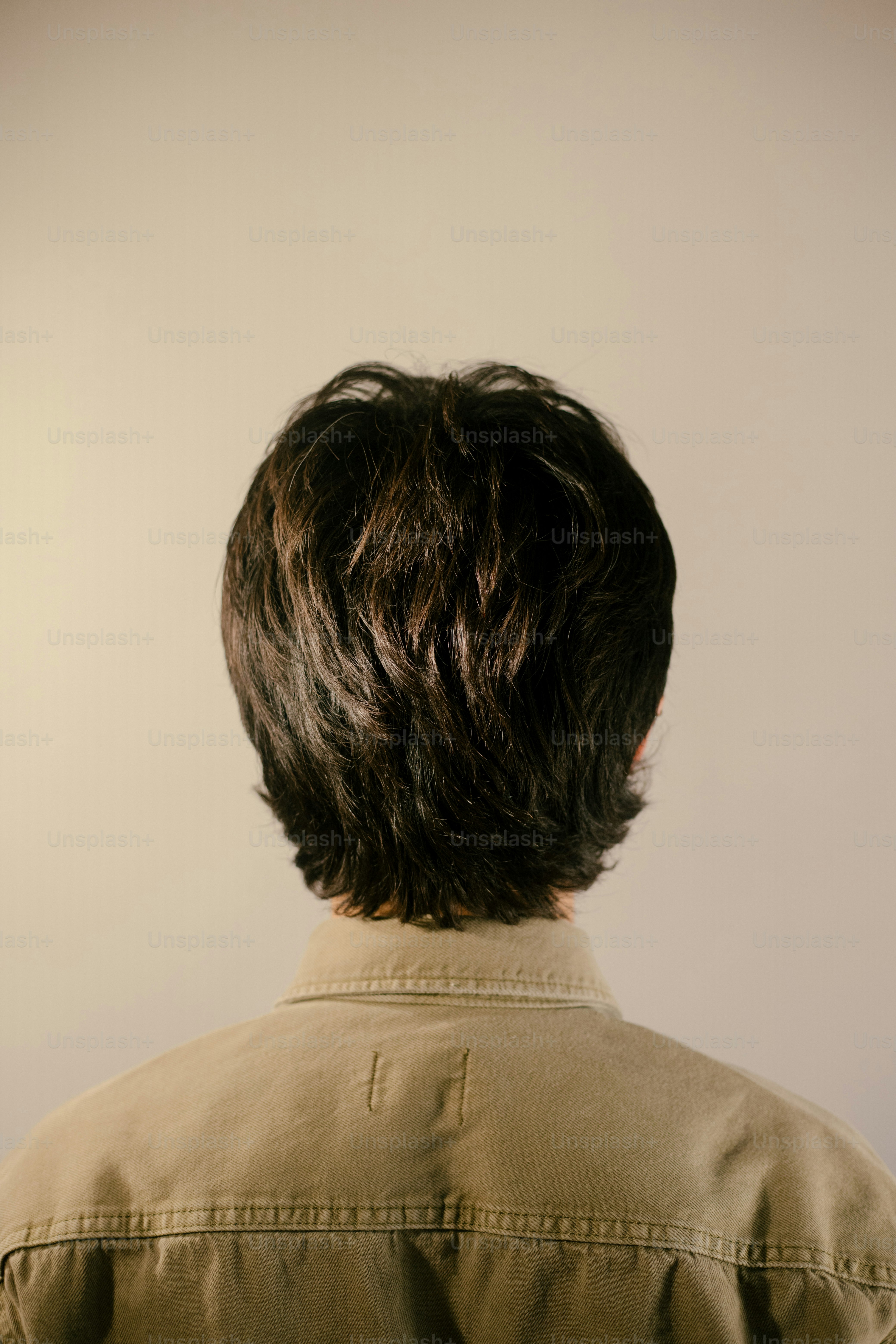 A person's back, looking at their hair.