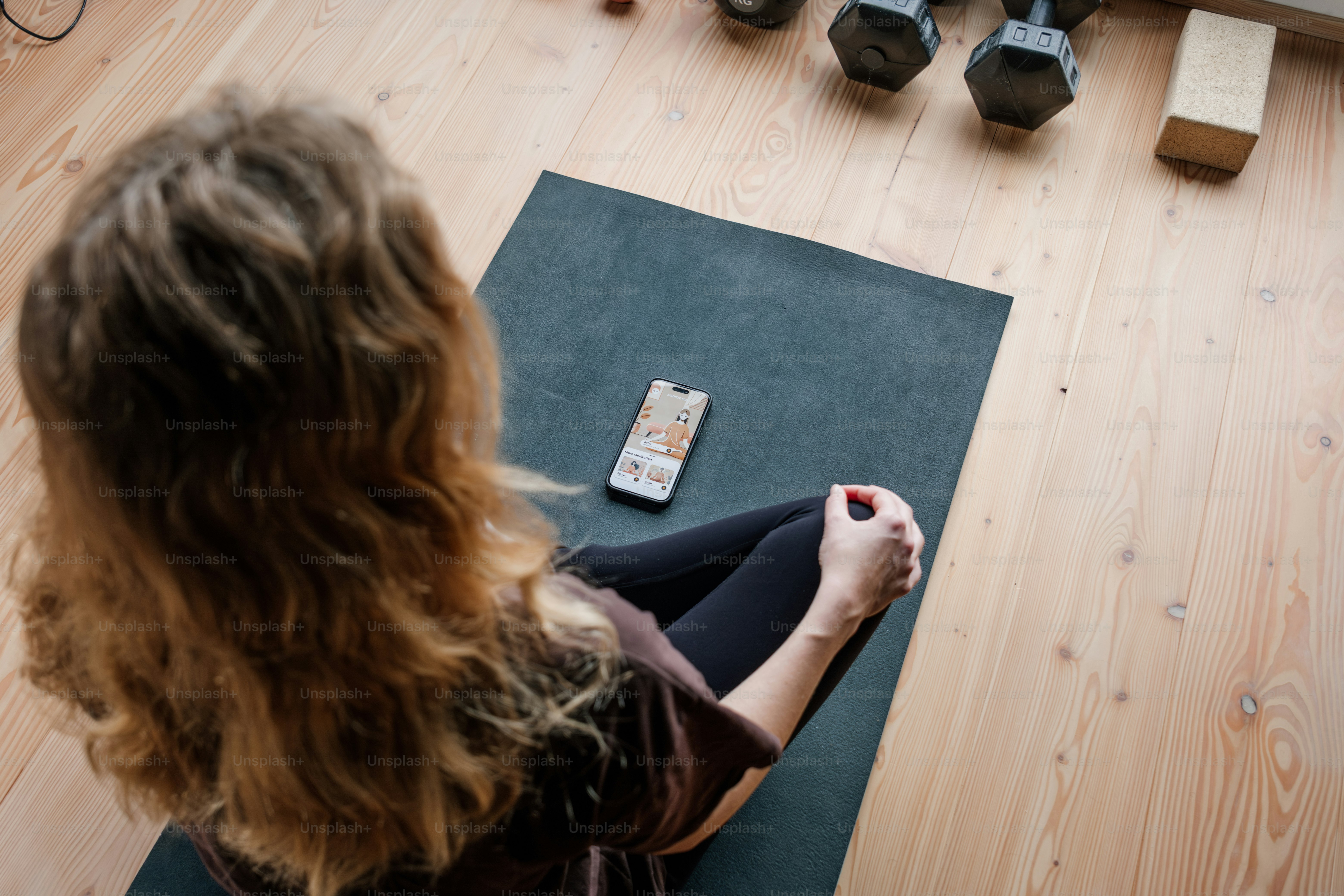 Woman prepares to work out with her phone.
