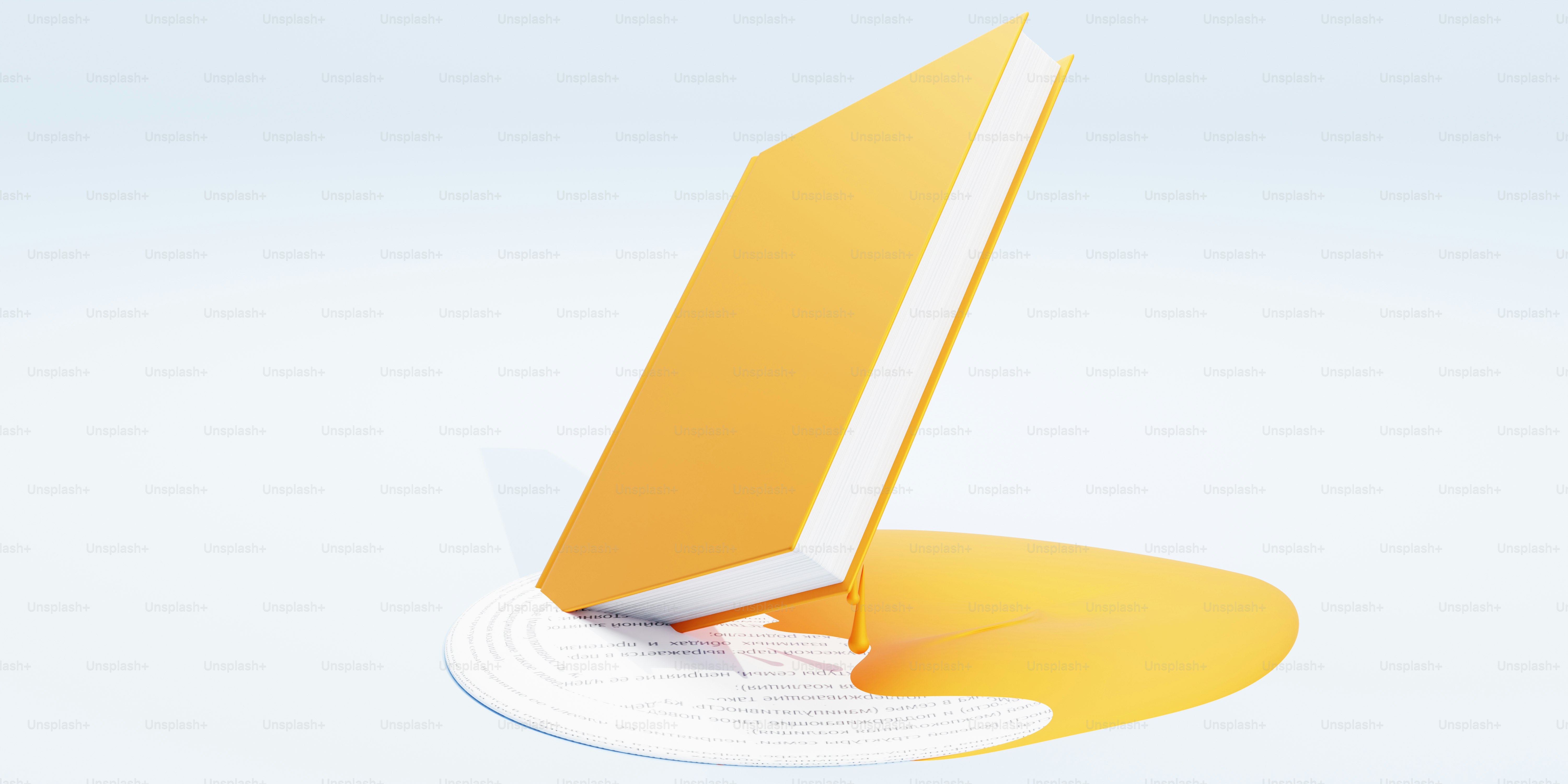A yellow book is placed on a yellow puddle.