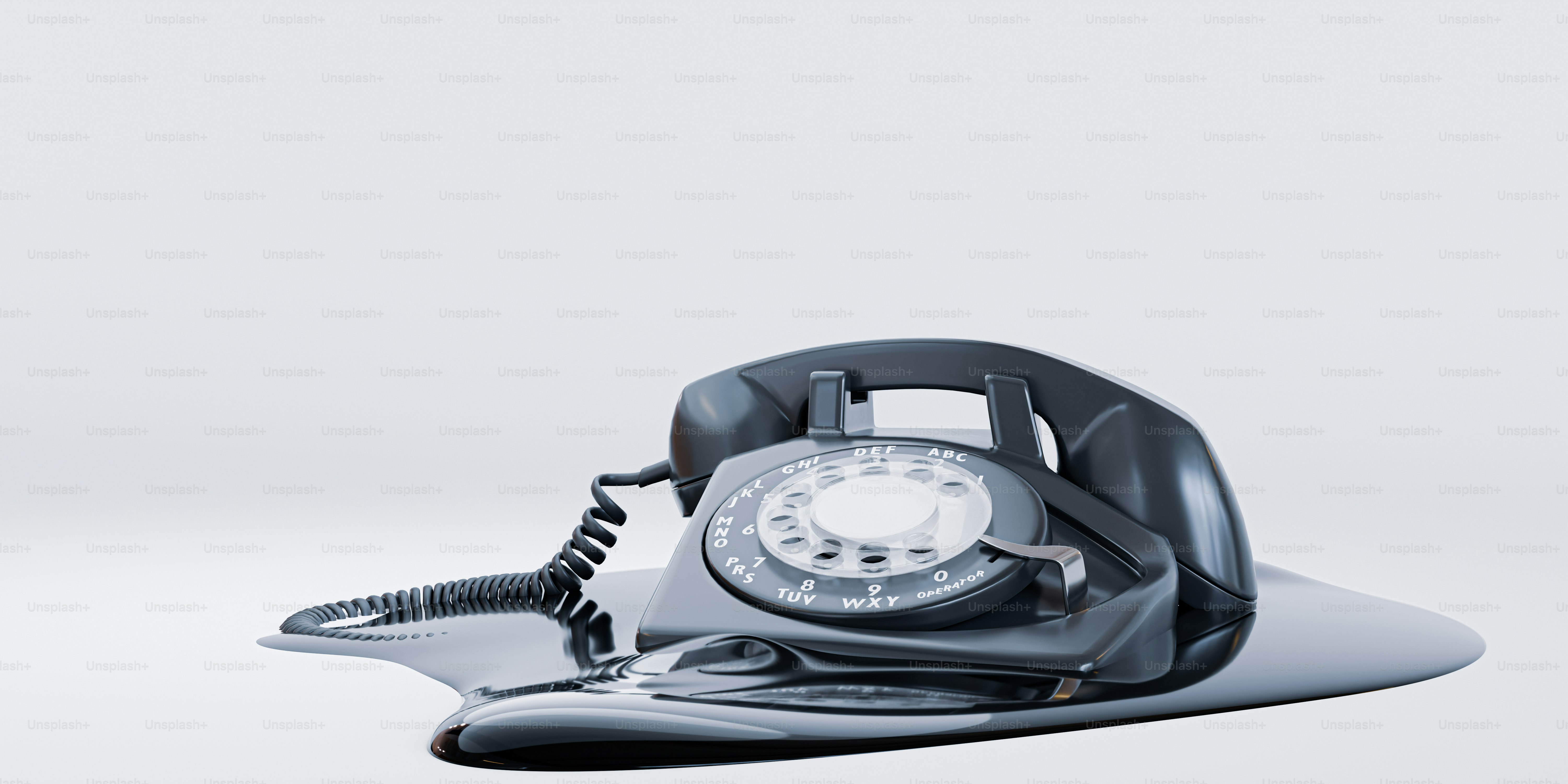 A retro telephone, melting on a white surface.