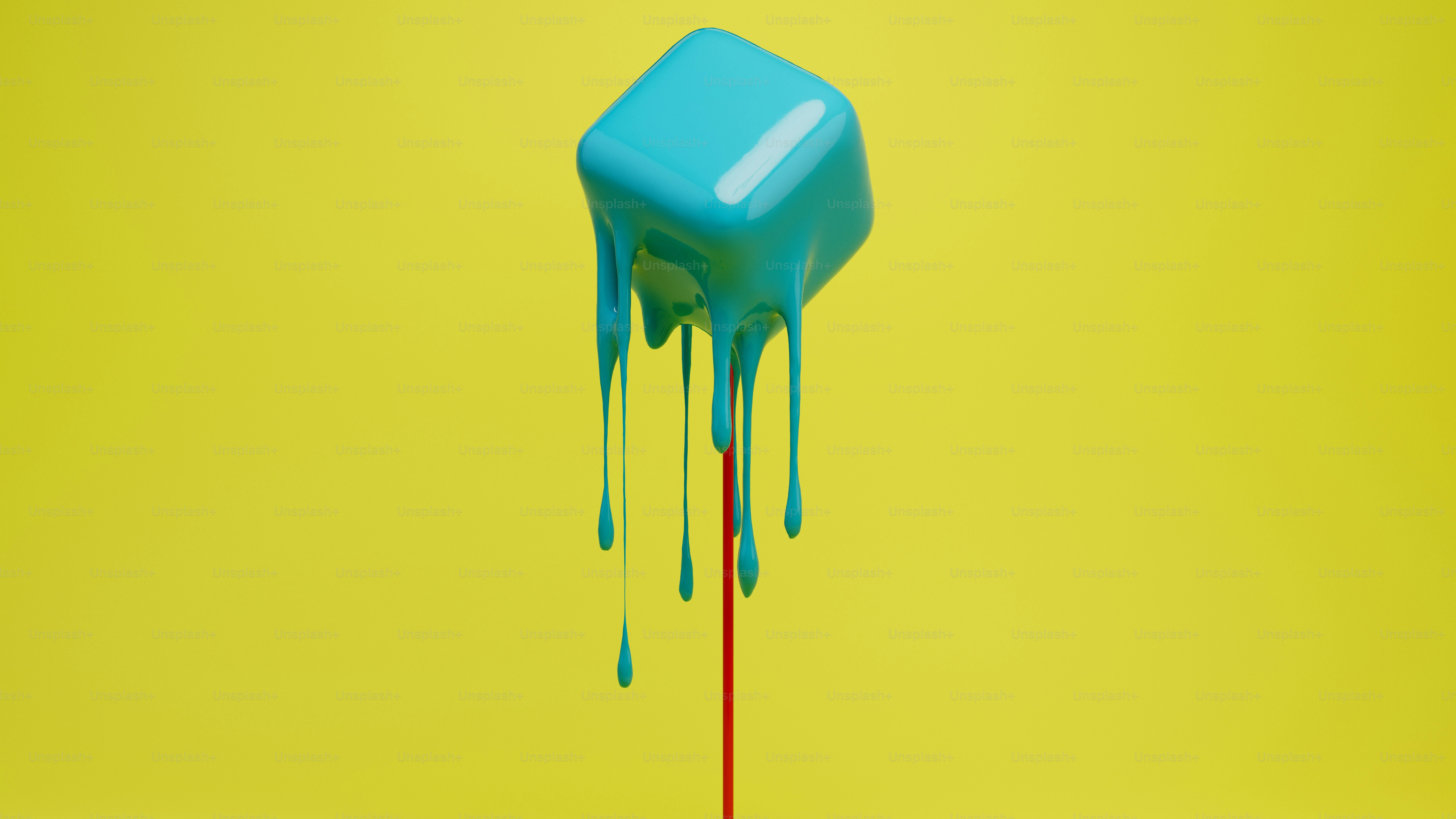 Um cubo azul-petróleo pingando contra um fundo amarelo.