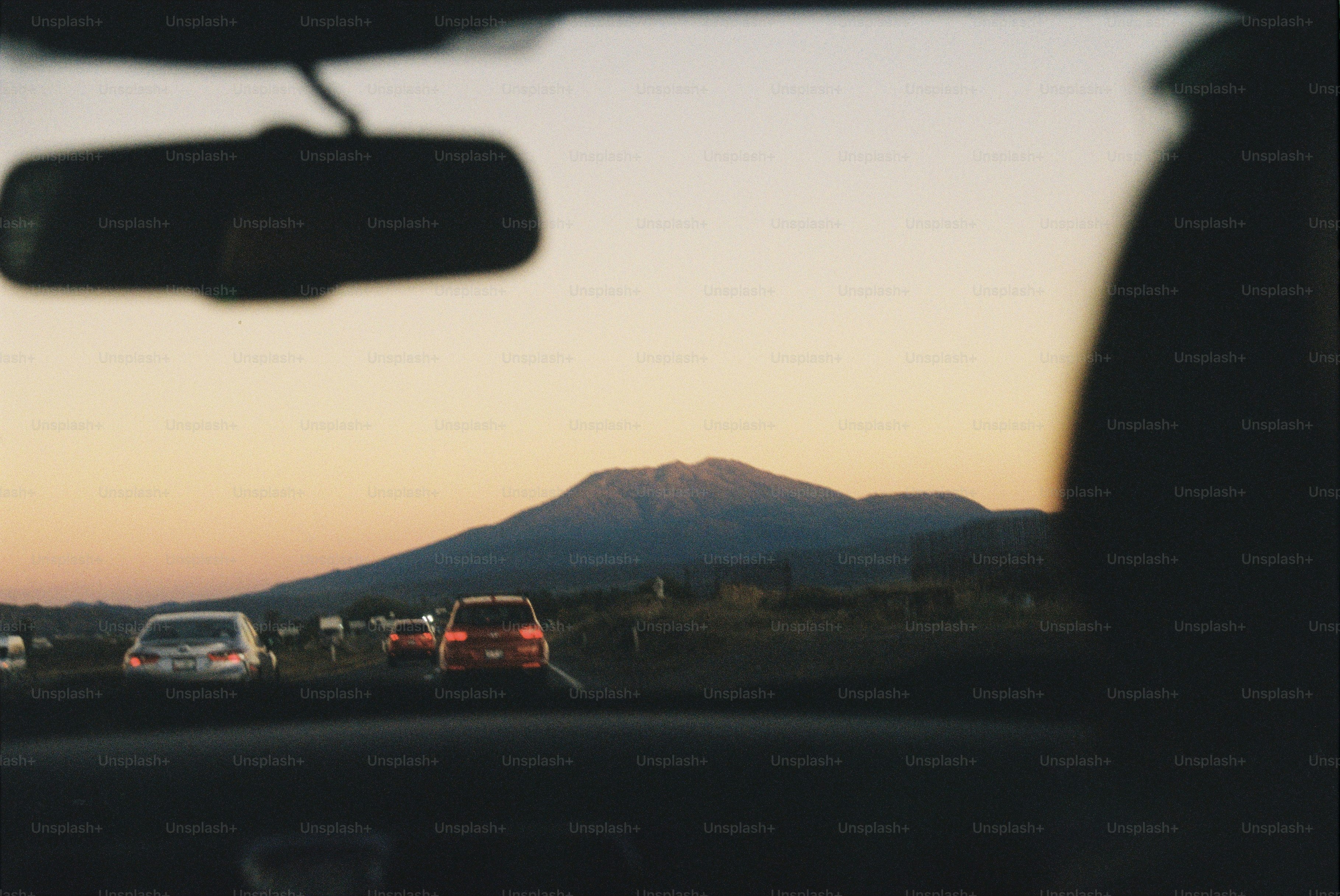 Driving on the road, mountain in the background.
