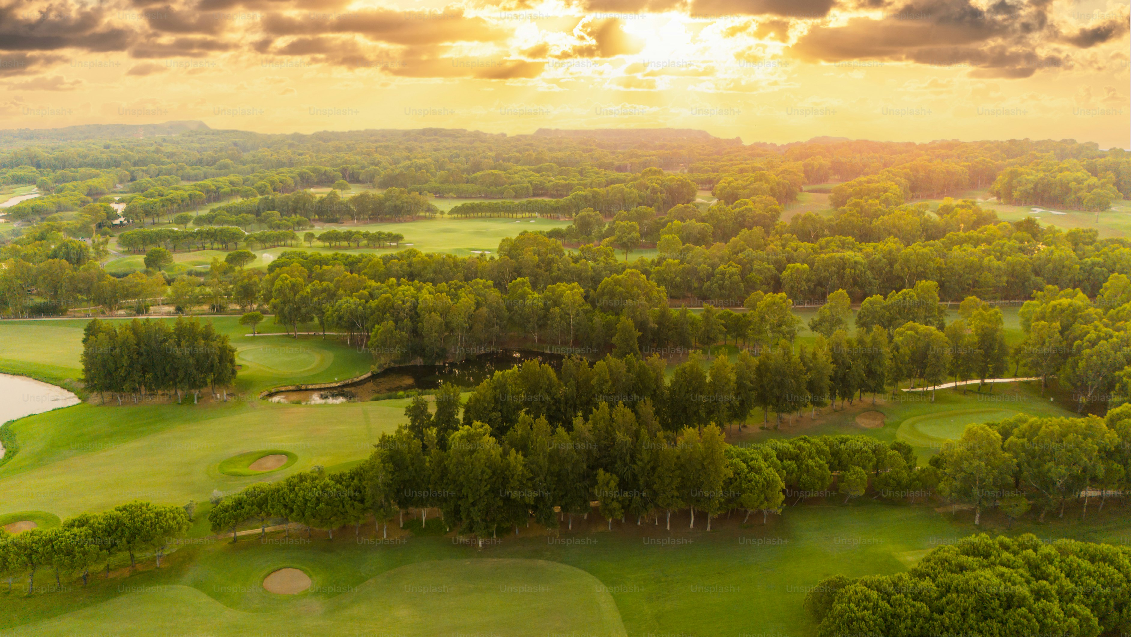Golf course at sunset. Scenic panoramic view of golf course at sunset ...
