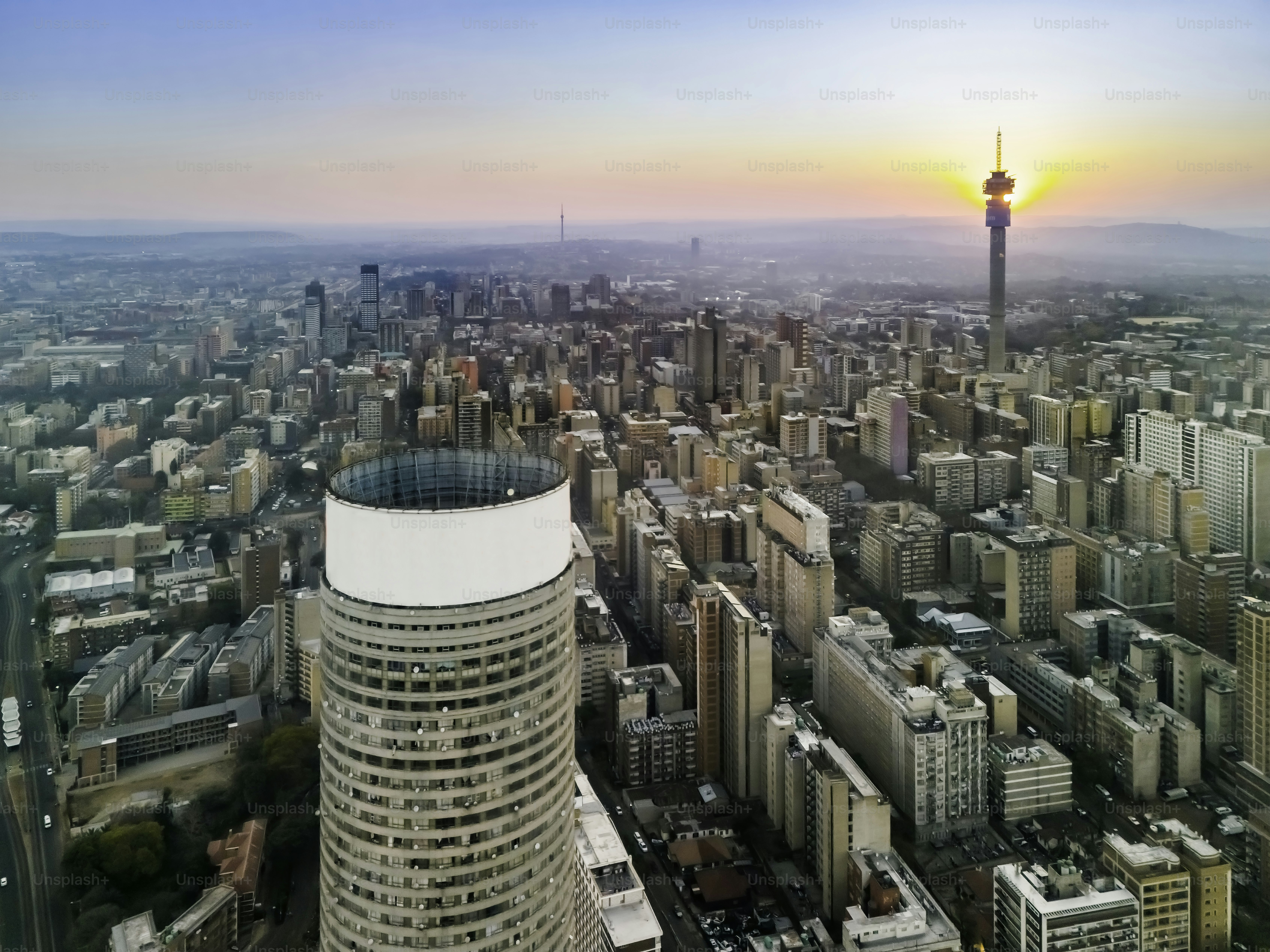 Hillbrow and Johannesburg with sun setting on the telkom communications tower seen from Ponte City apartments. Johannesburg is also known as Jozi, Jo'burg or eGoli, is the largest city in South Africa.