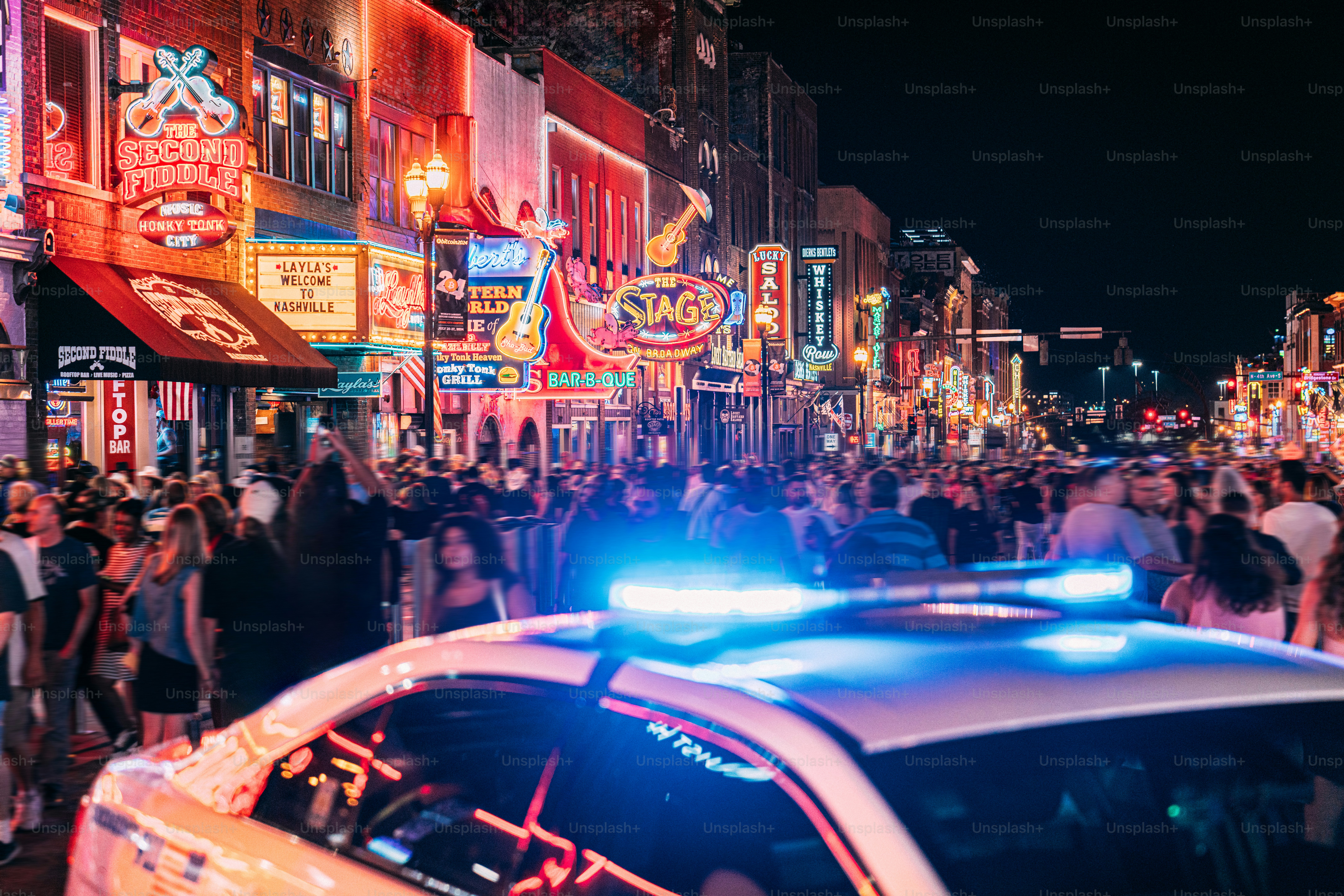 Nashville Metro Police Car Cruiser Parked on Broadway in Nashville to Deter Tourists and visitors from drug use, crime, or harassment at the bars and honky-tonks in the country music center, Downtown Nashville, Tennessee