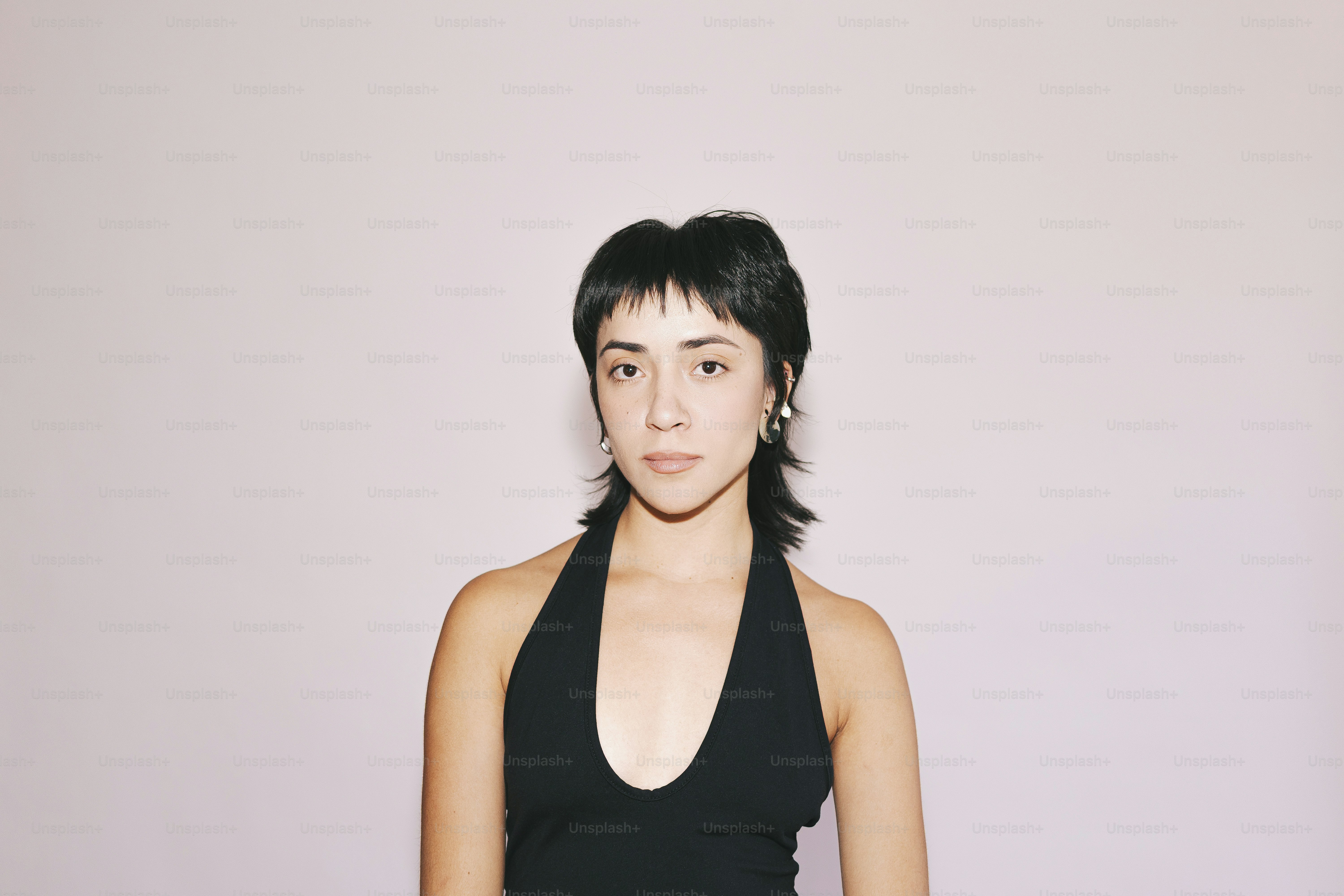 A woman poses in a black halter top.