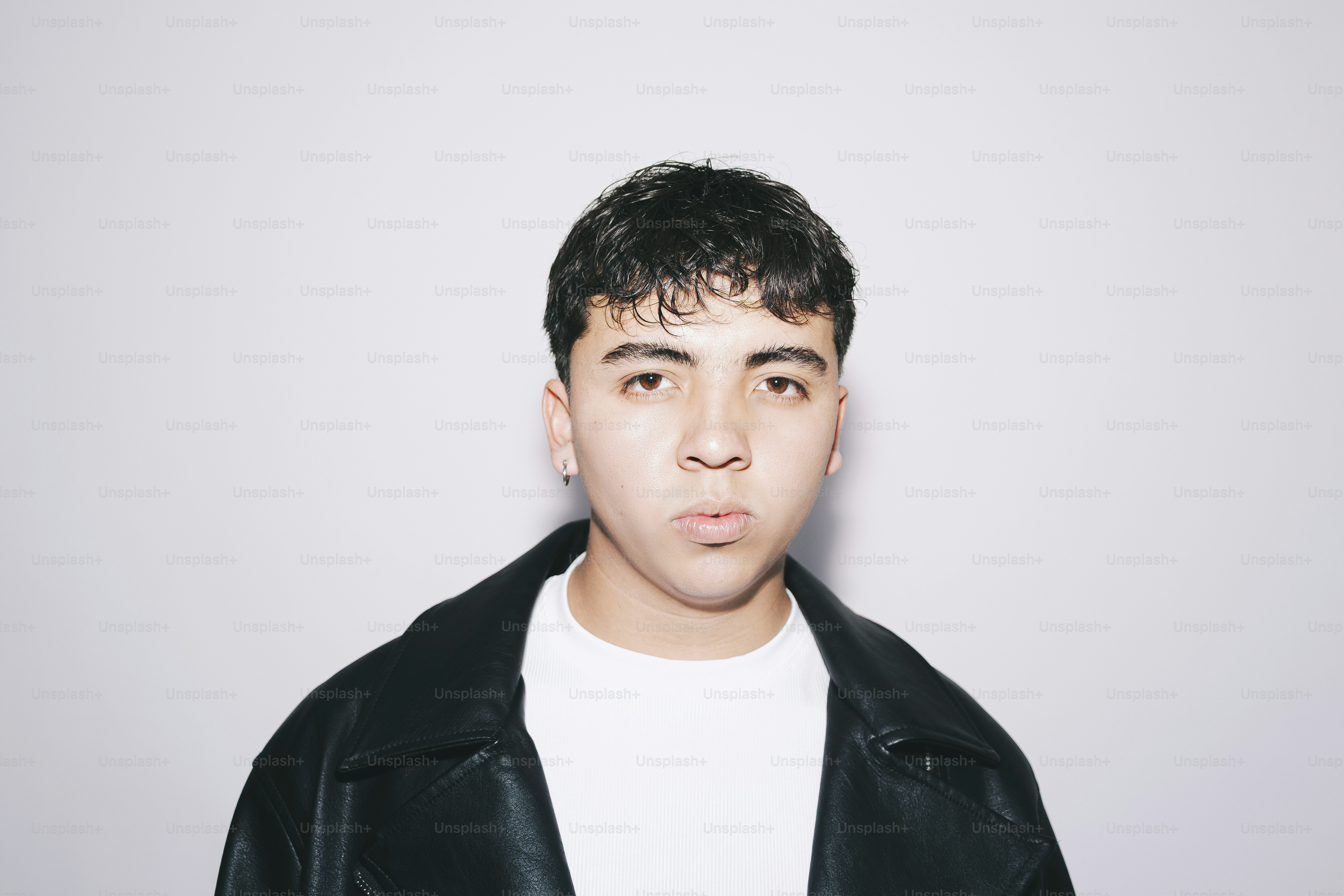 A young man poses for a portrait.