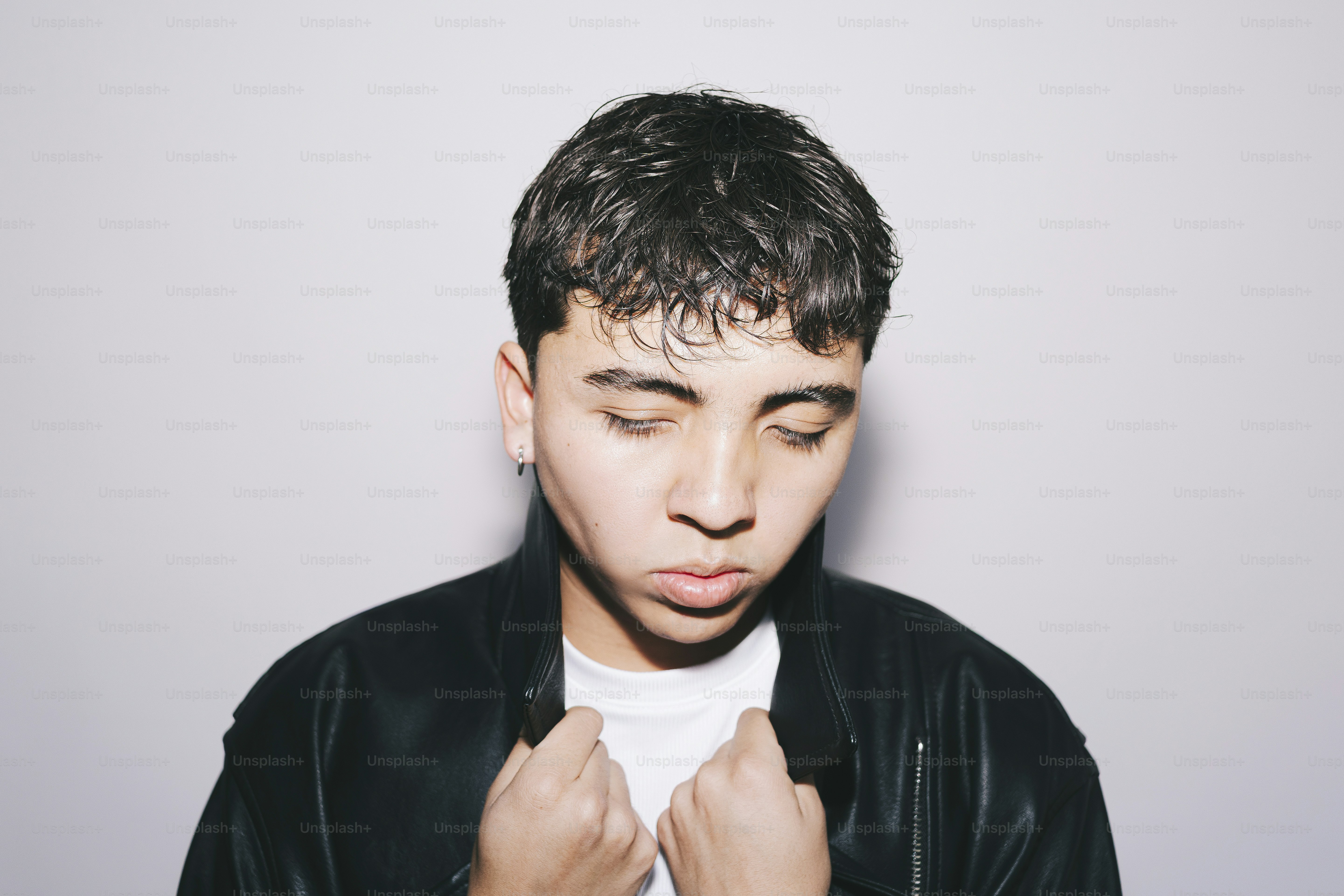 Young person looking down, thoughtfully poses for a photo.