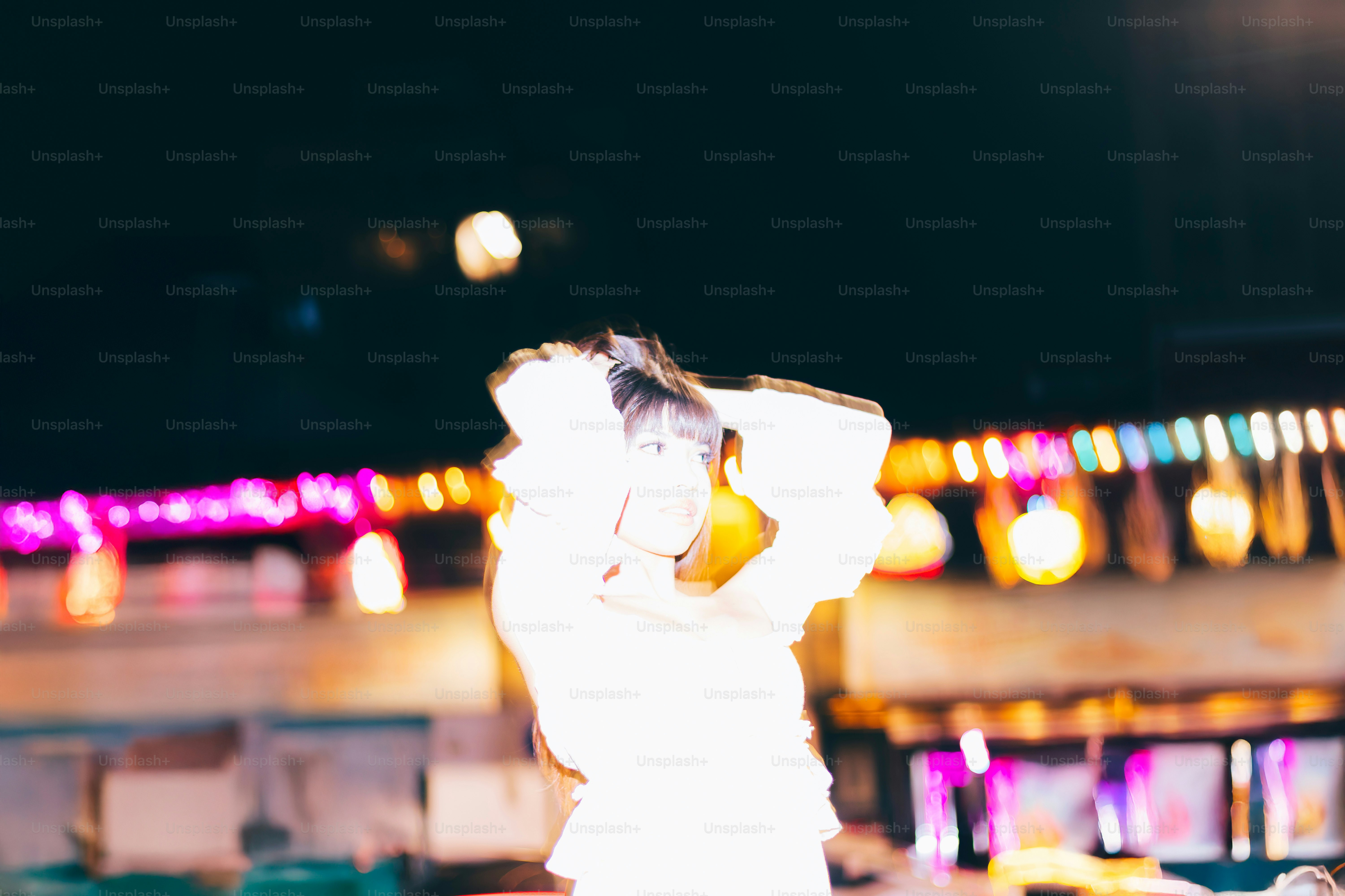 Woman poses with her hands in her hair.