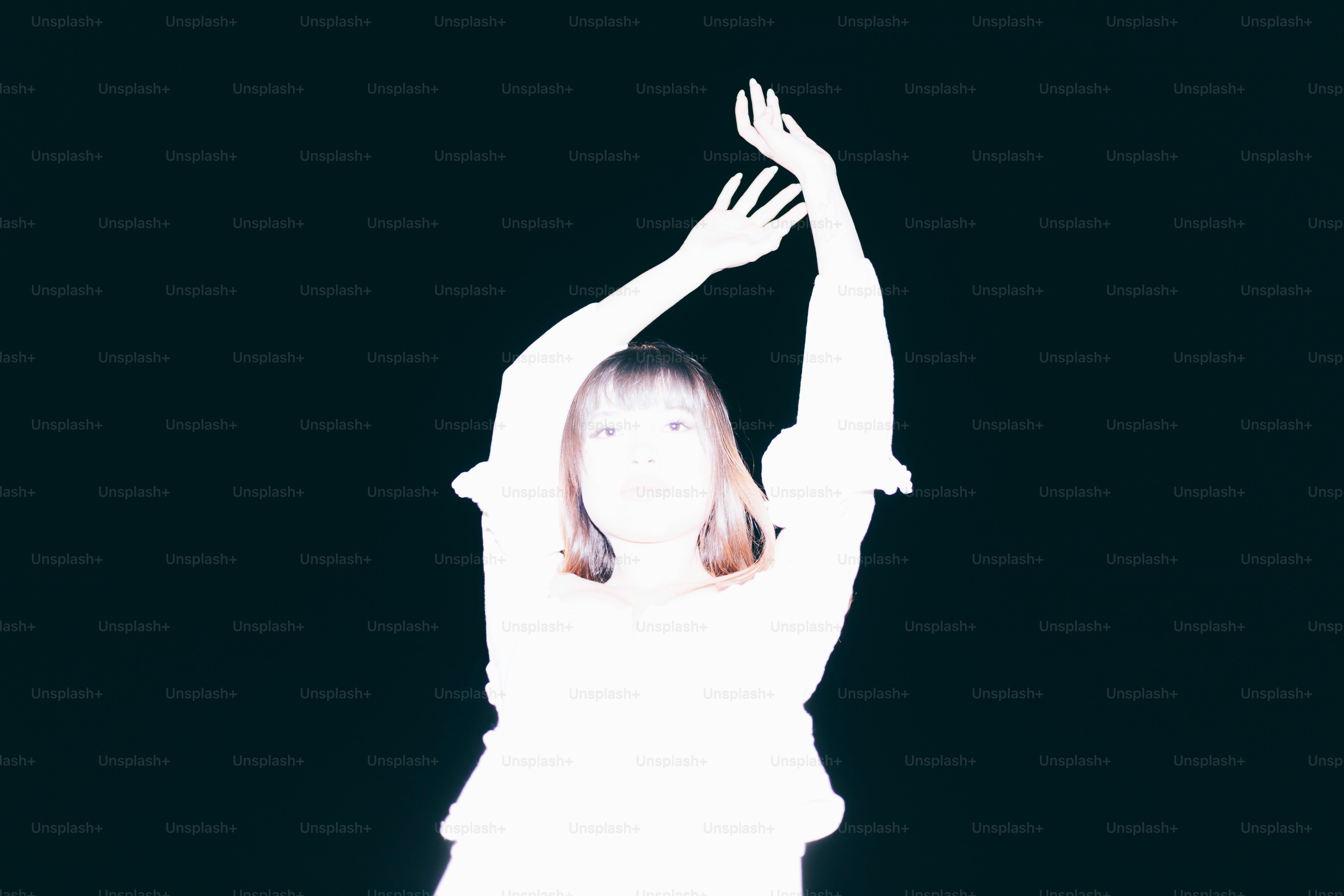 A glowing figure poses with arms raised.