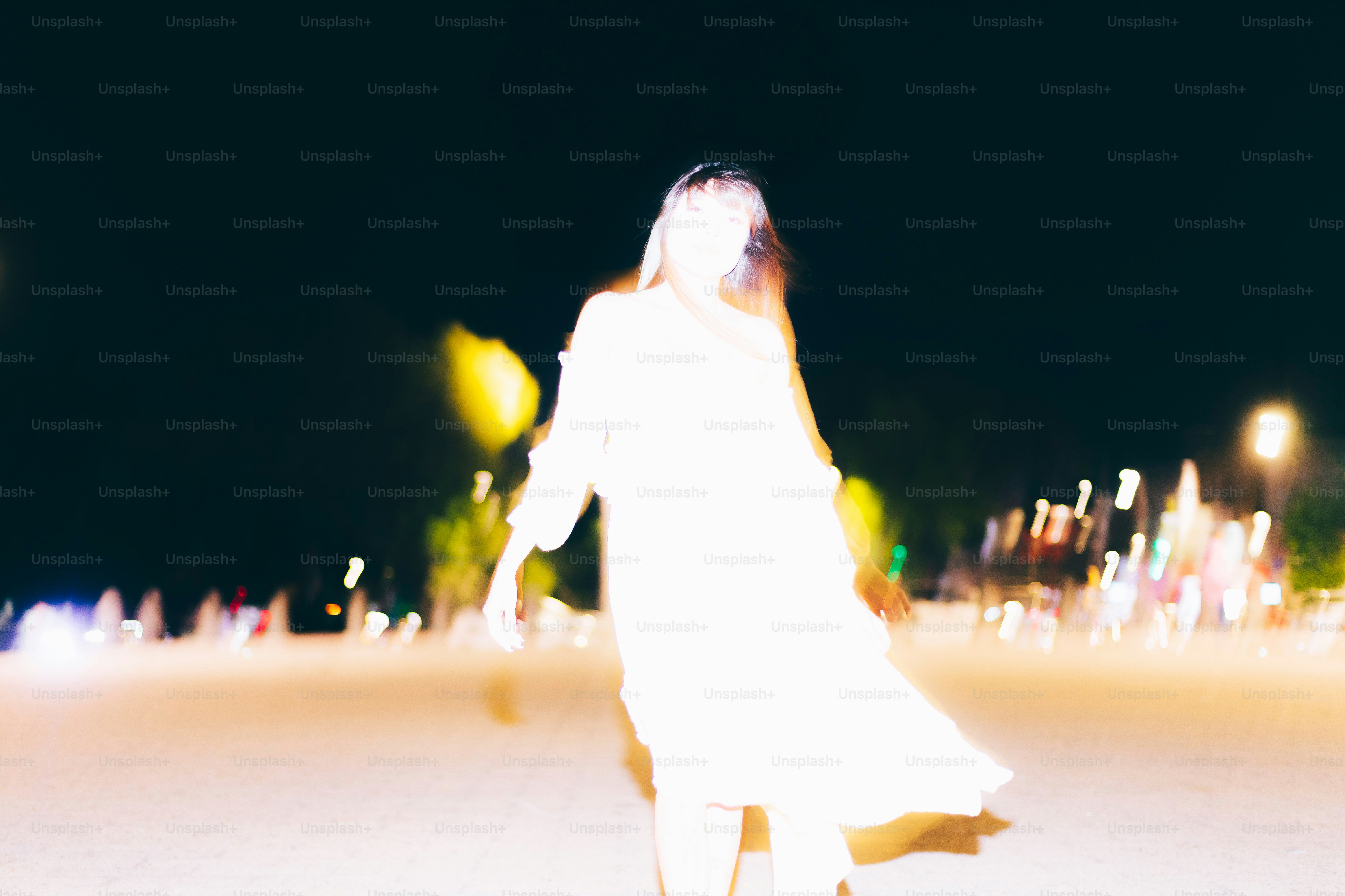 A blurry figure is seen walking at night.
