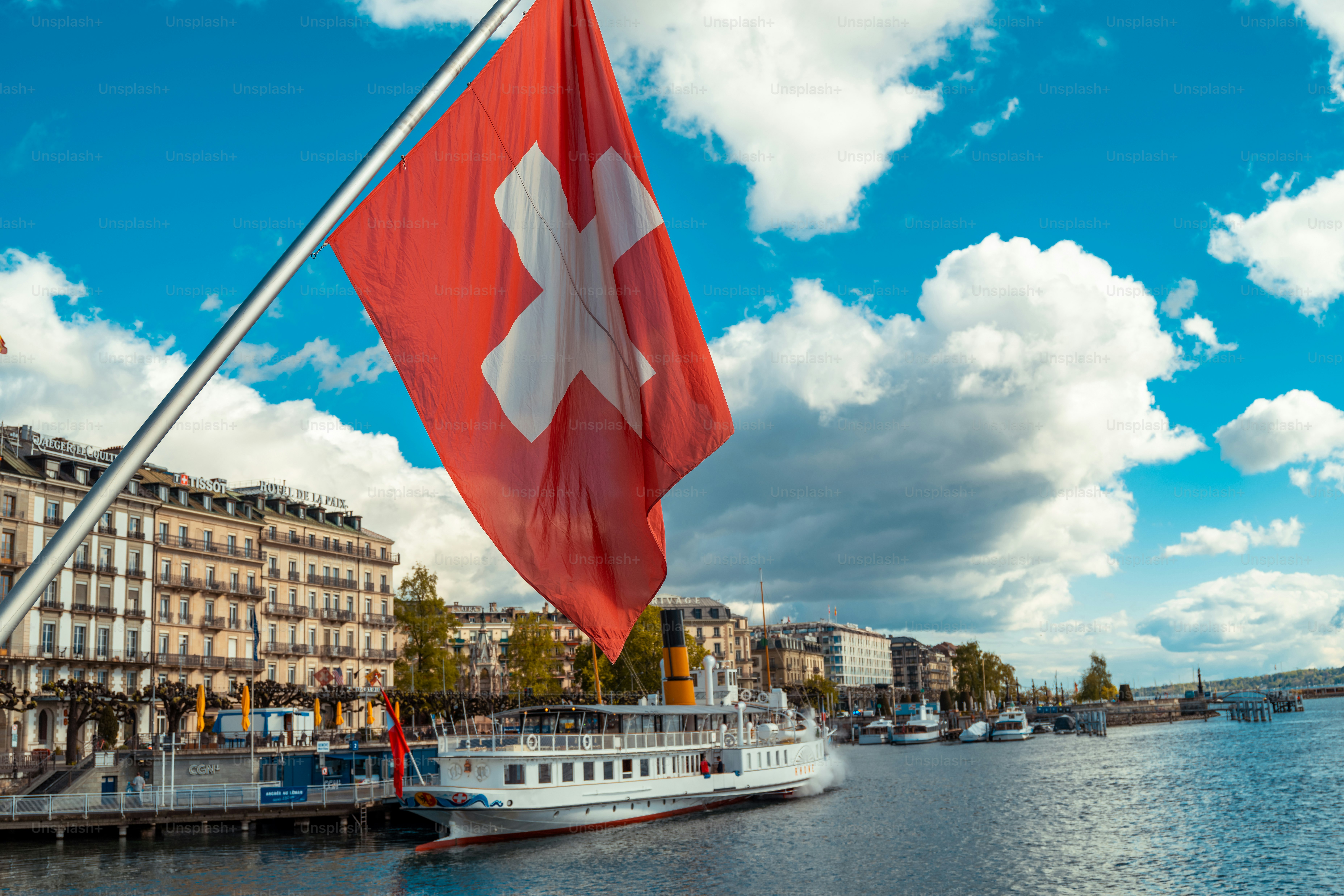 Swiss flag with view of Geneva city, Switzerland