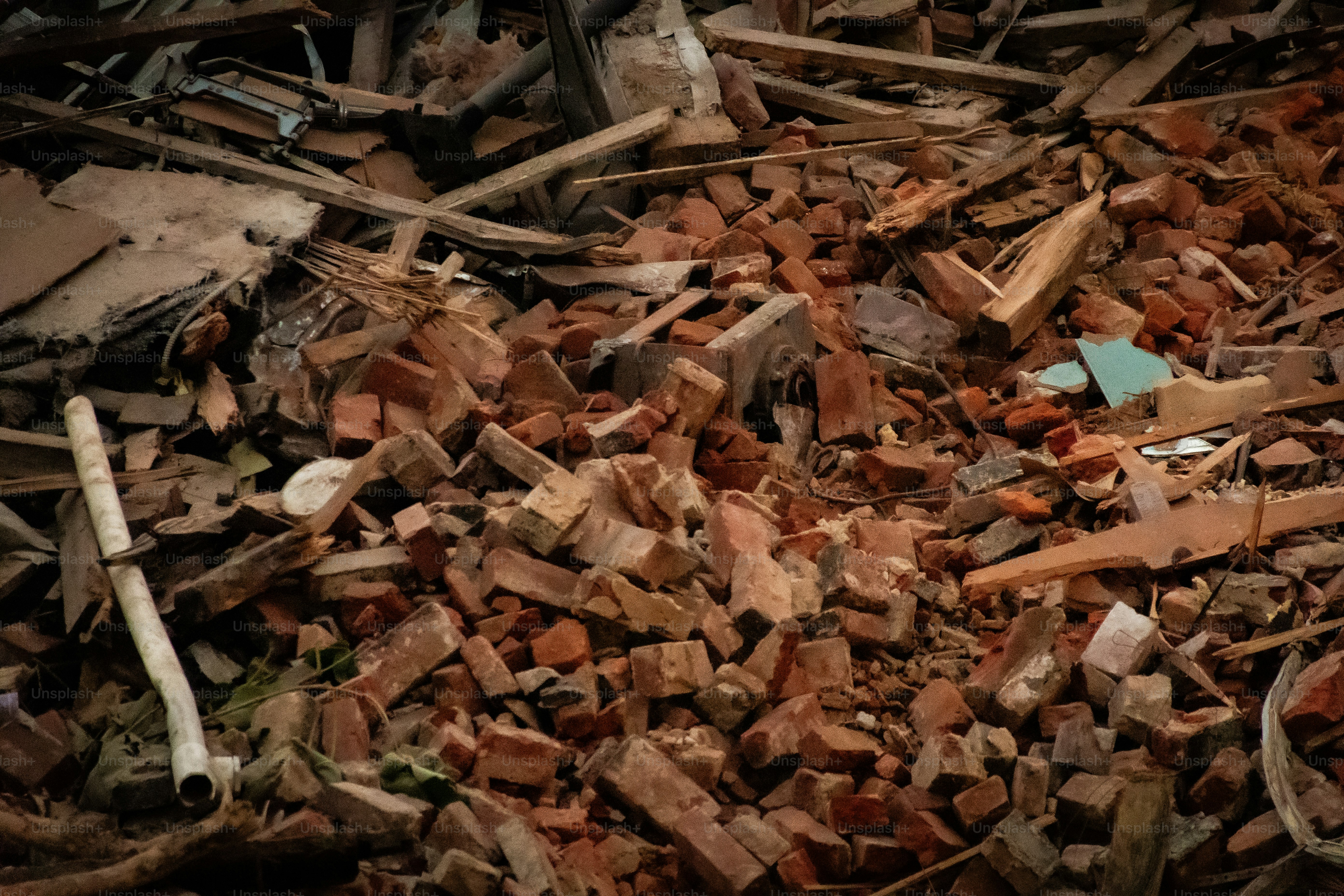 View from a window of a construction site destroying an old building, with bricks and all furniture inside with a huge crane claw