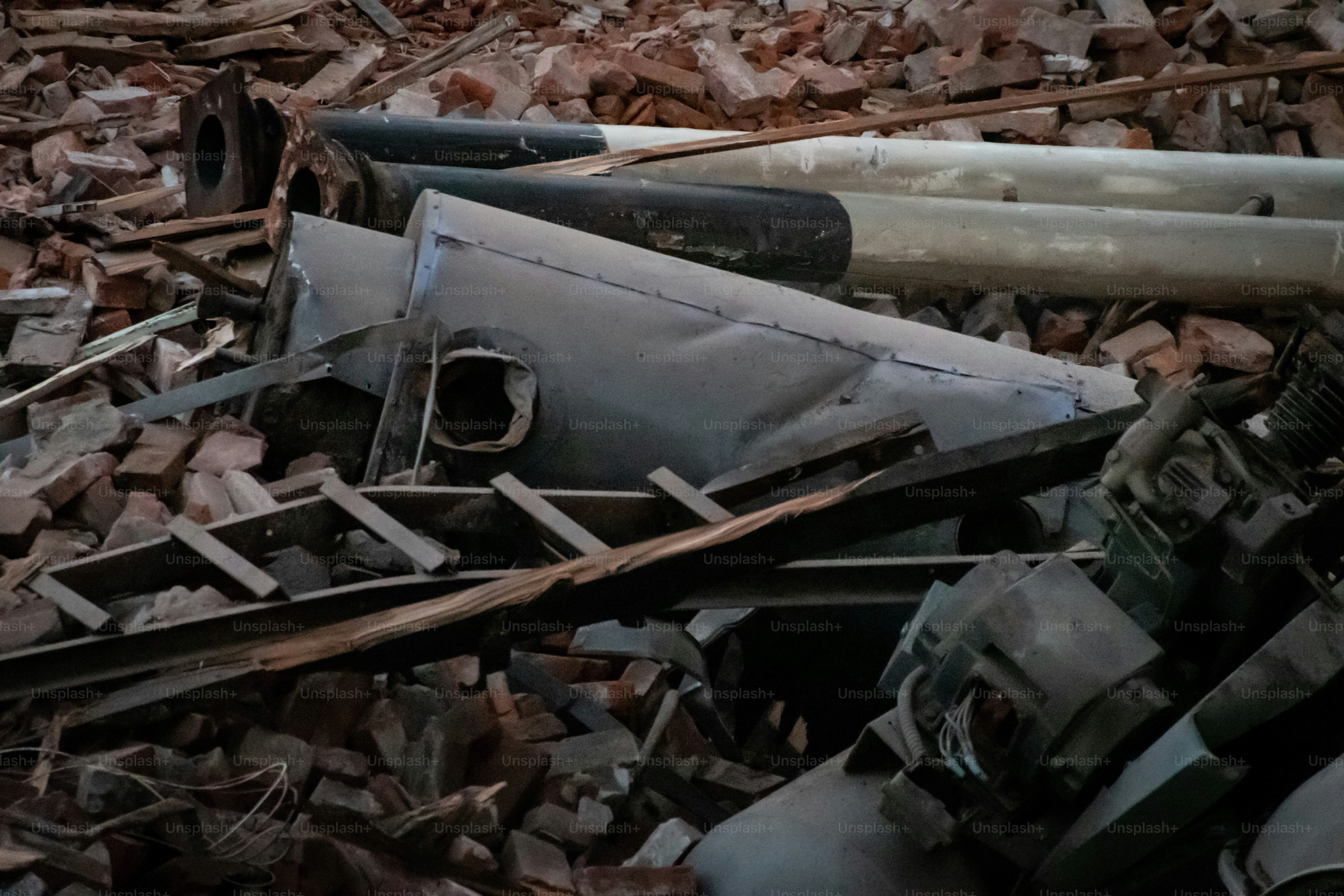 View from a window of a construction site destroying an old building, with bricks and all furniture inside with a huge crane claw
