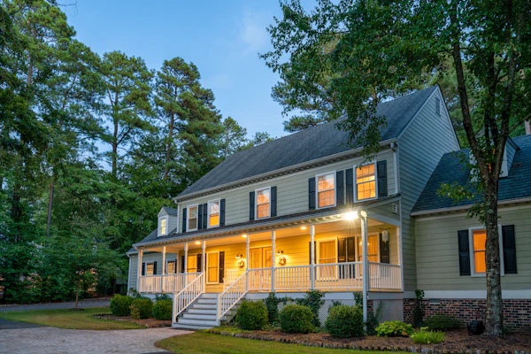 Illuminated luxury Colonial home at dusk