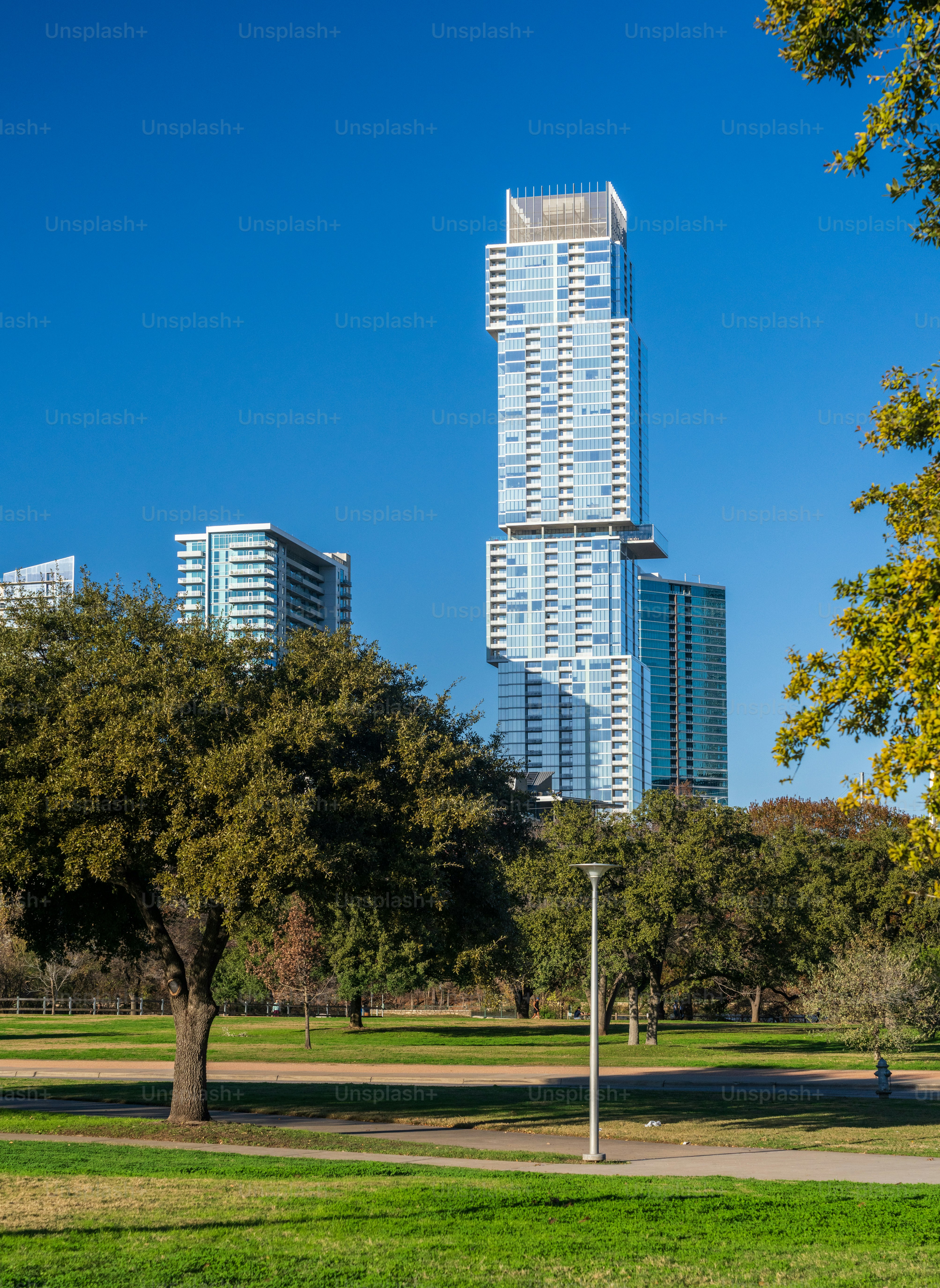 Unusual shapre of design of apartments and condos in Austin Texas seen from the Town Lake Park