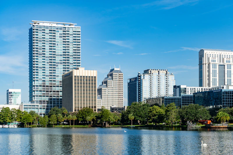 Orlando convention center - Downtown Orlando cityscape reflecting in Lake Eola on a summer day in Florida, USA.