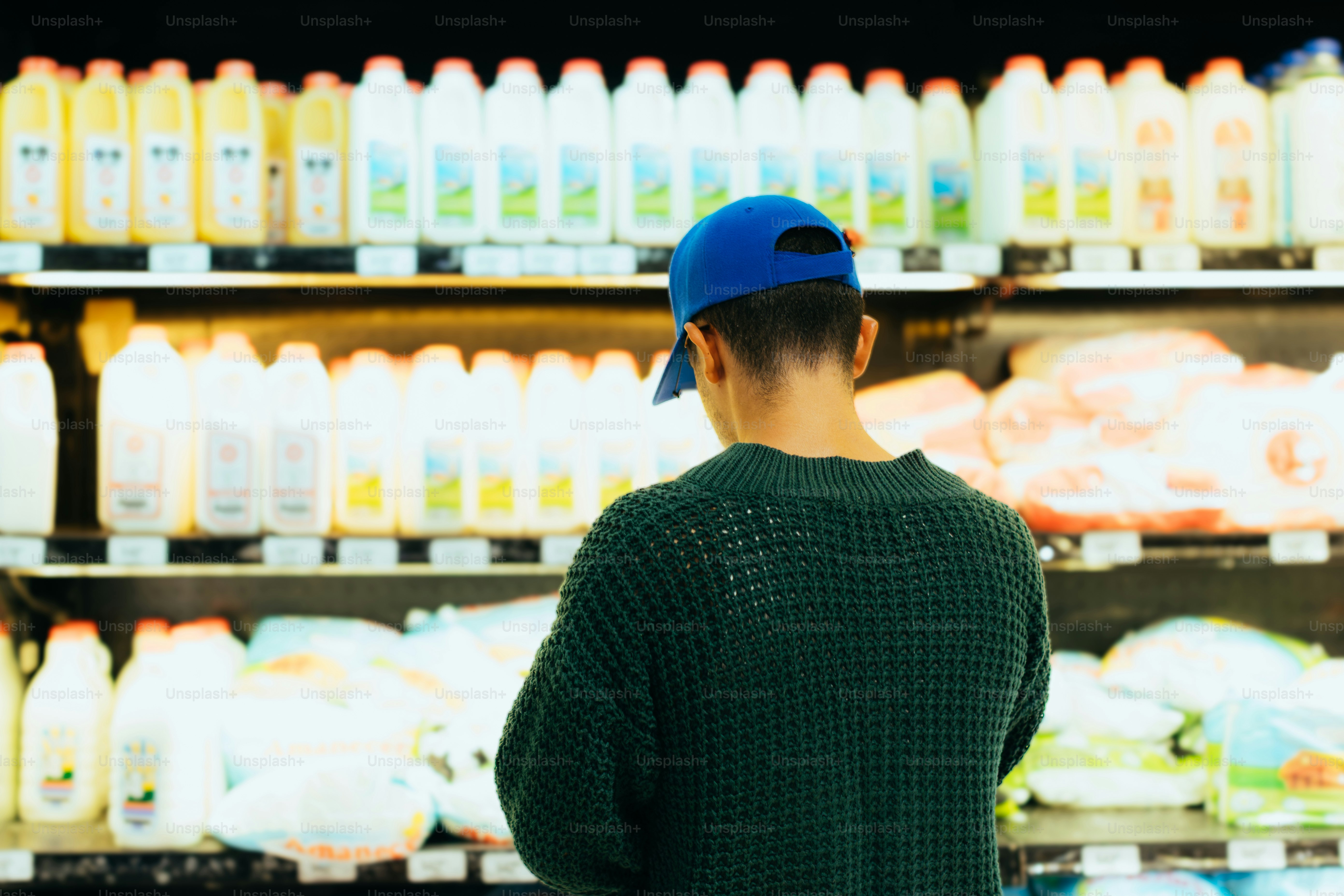 Person shopping for milk in a grocery store.