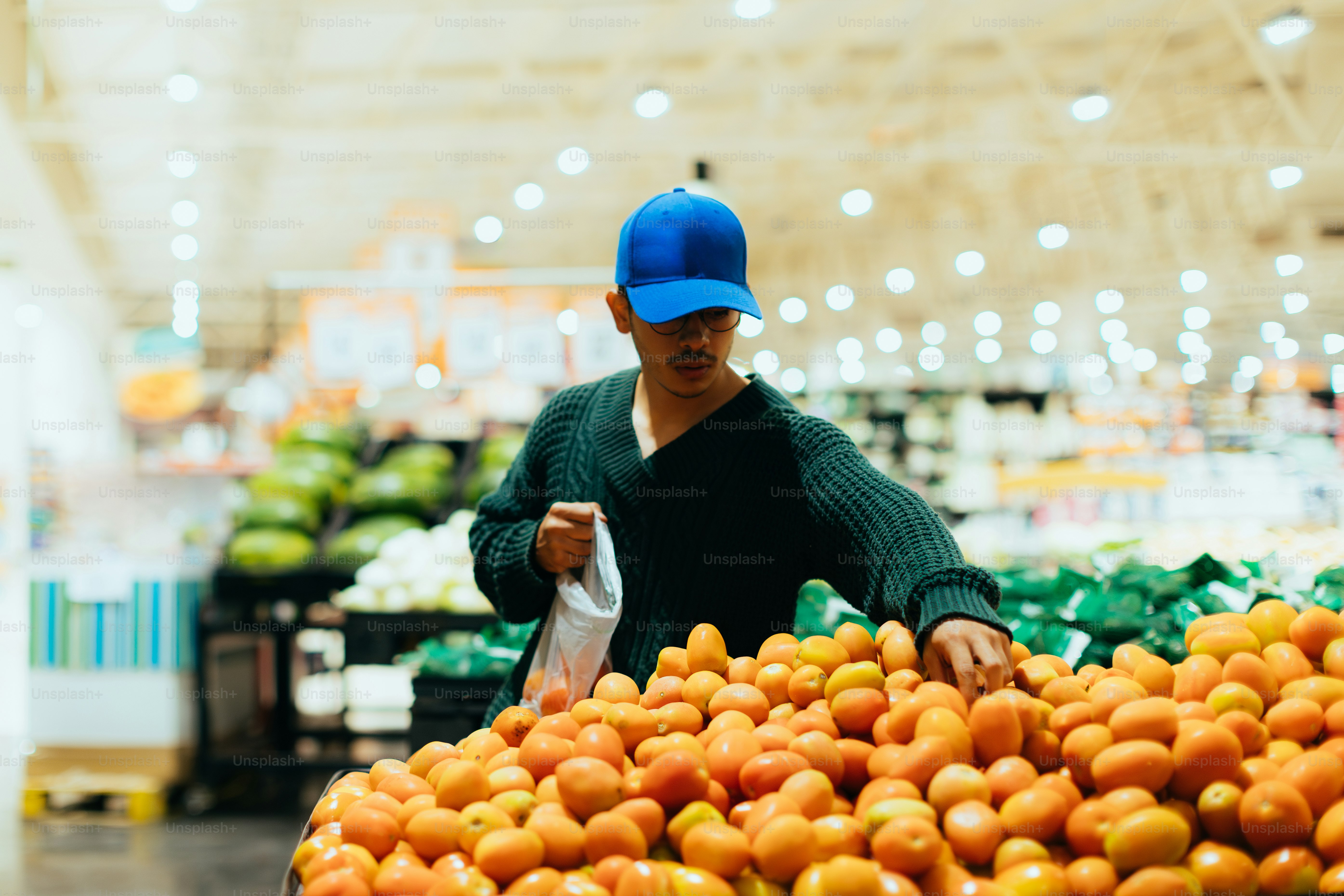 A man shops for produce at the grocery store.